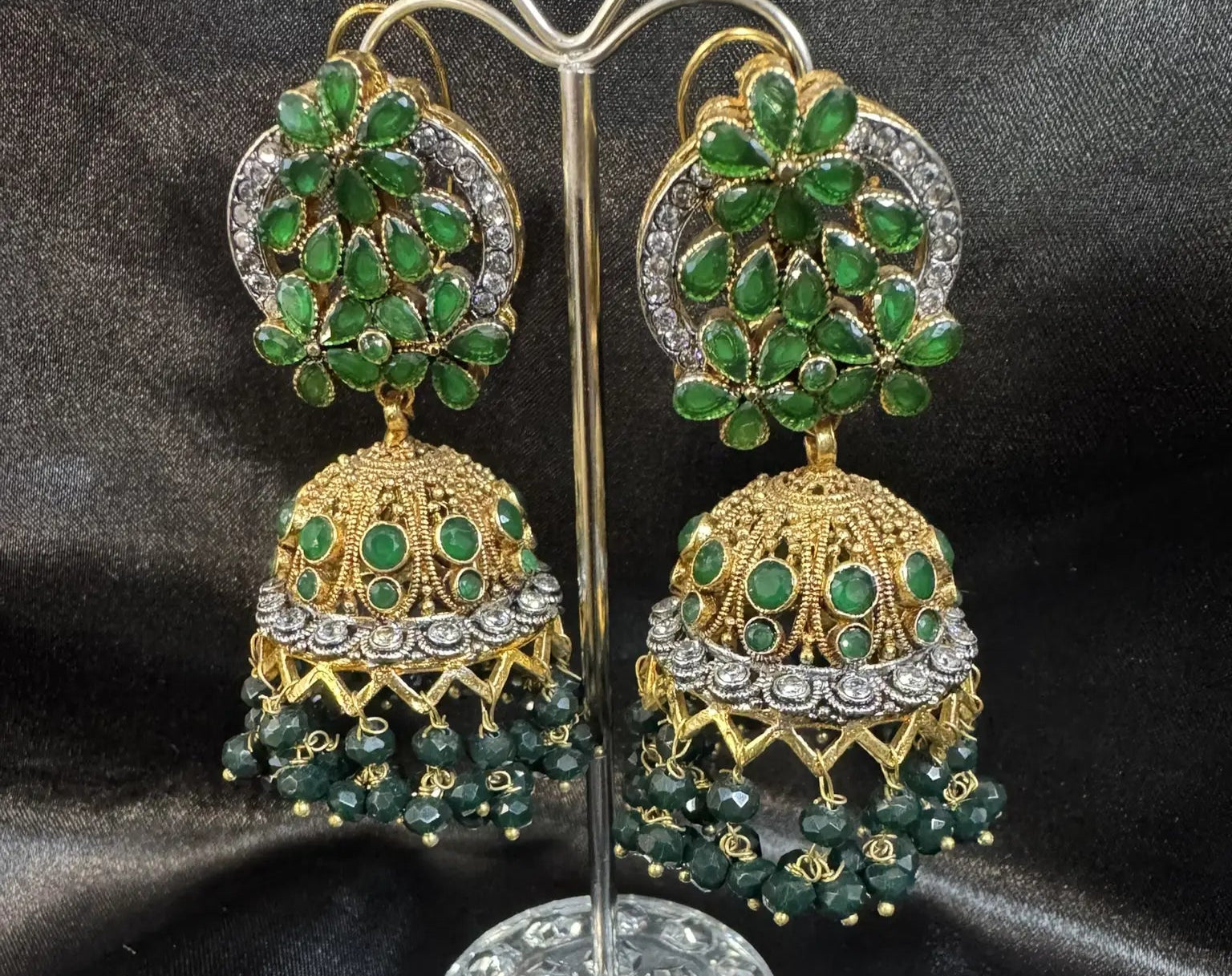 Pakistani design gold-plated jhumkay with green colored gemstones and floral accents