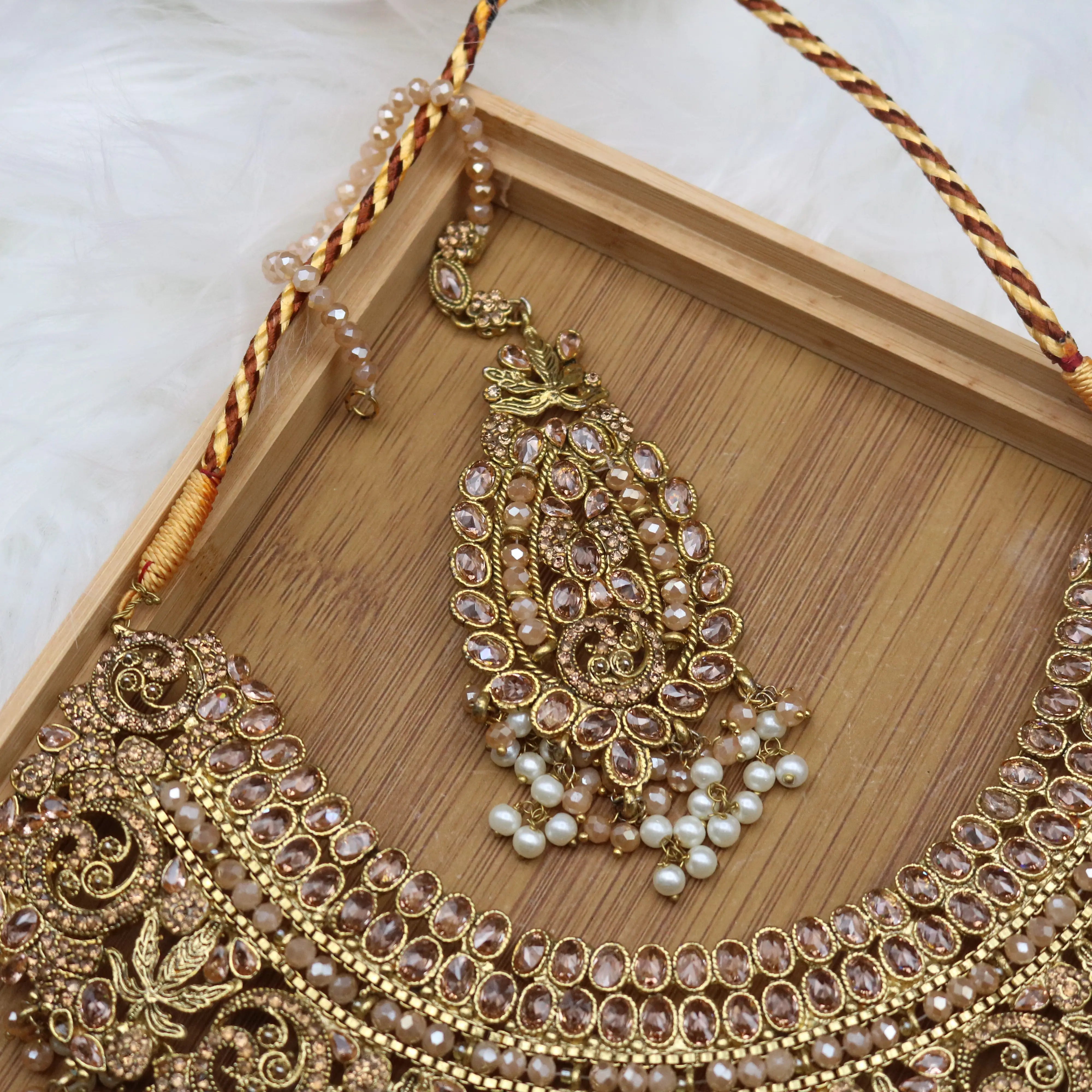 teeka view of Gold and champagne Pakistani bridal necklace jewelry set with jhoomer