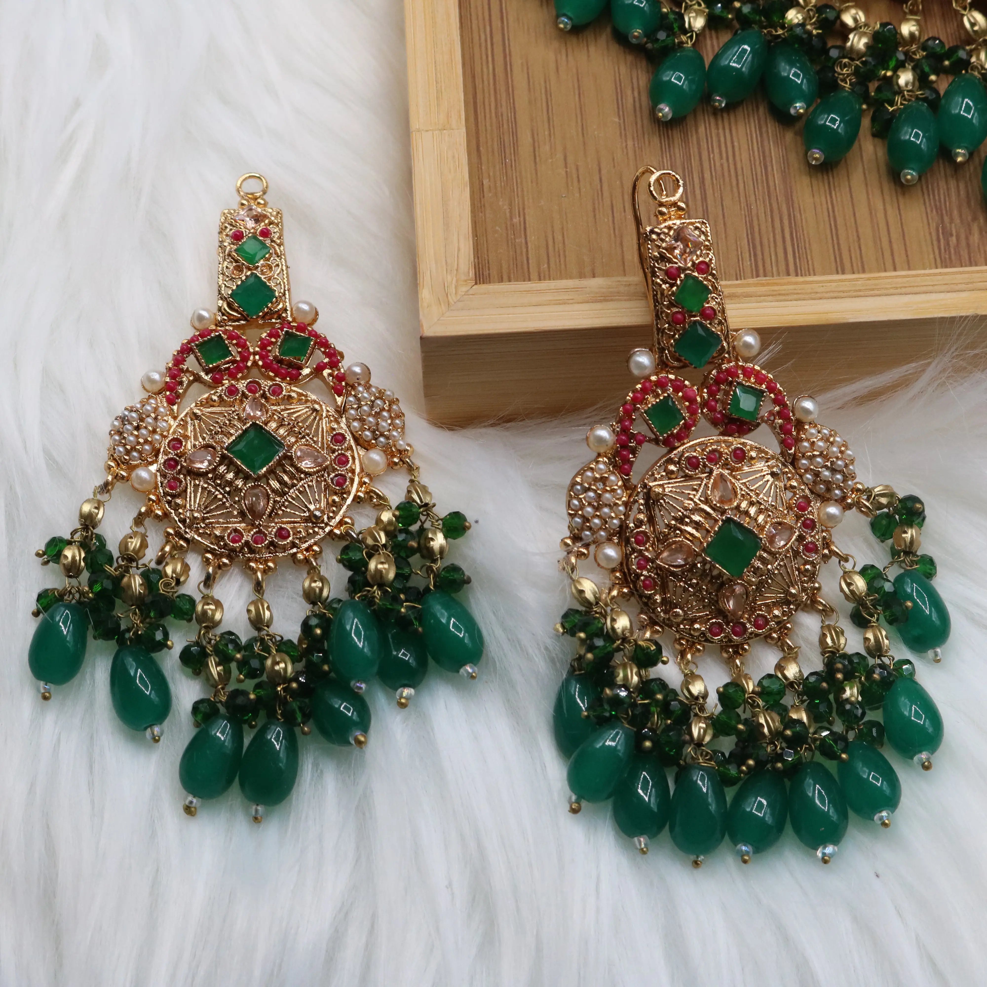 Earrings view of Pakistani bridal set handcrafted with intricate gold-plated detailing, this traditional jewelry set features red stone inlays, sparkling accents, and rich green bead drops