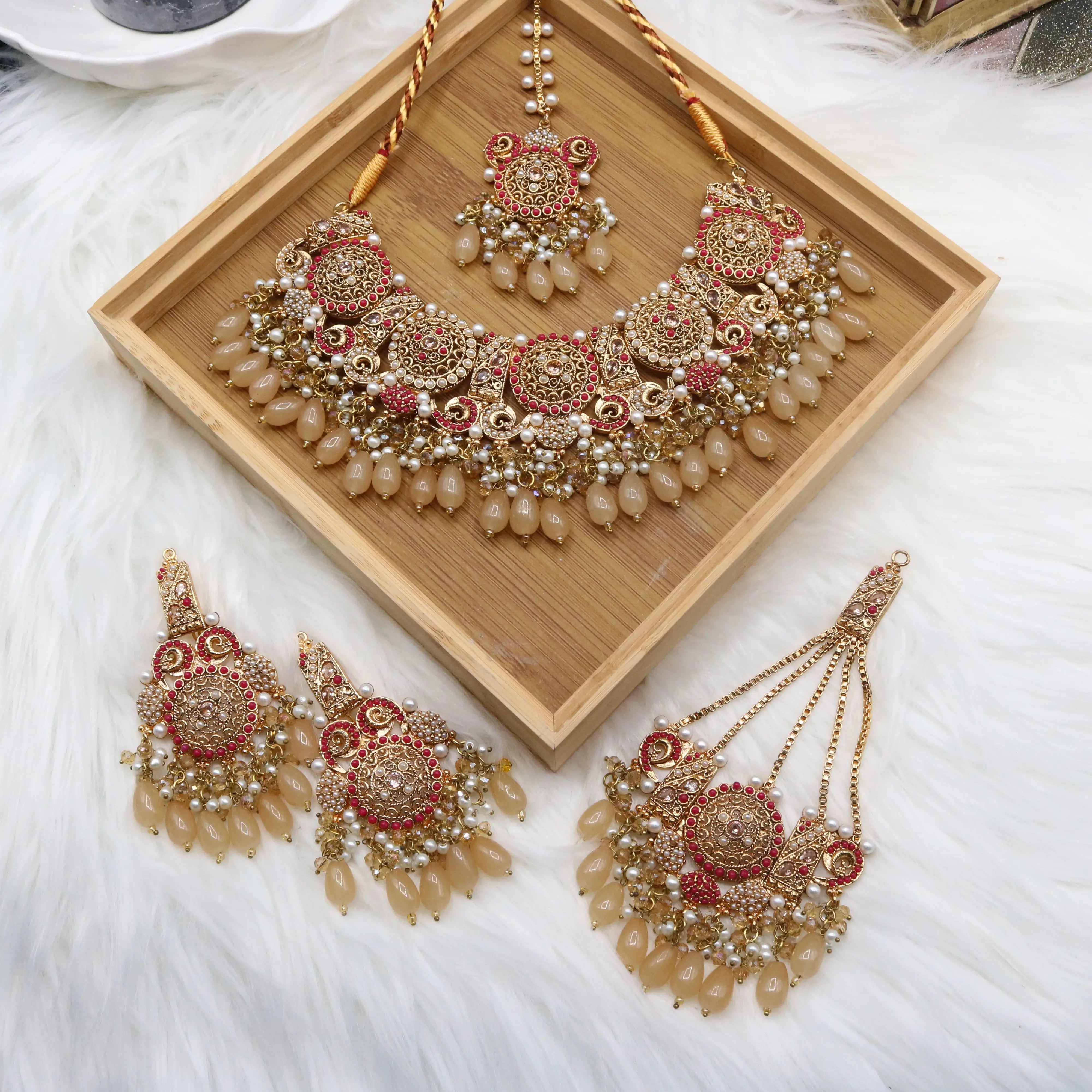 Traditional bridal jewelry set with beige stones, pearls and antique gold finish