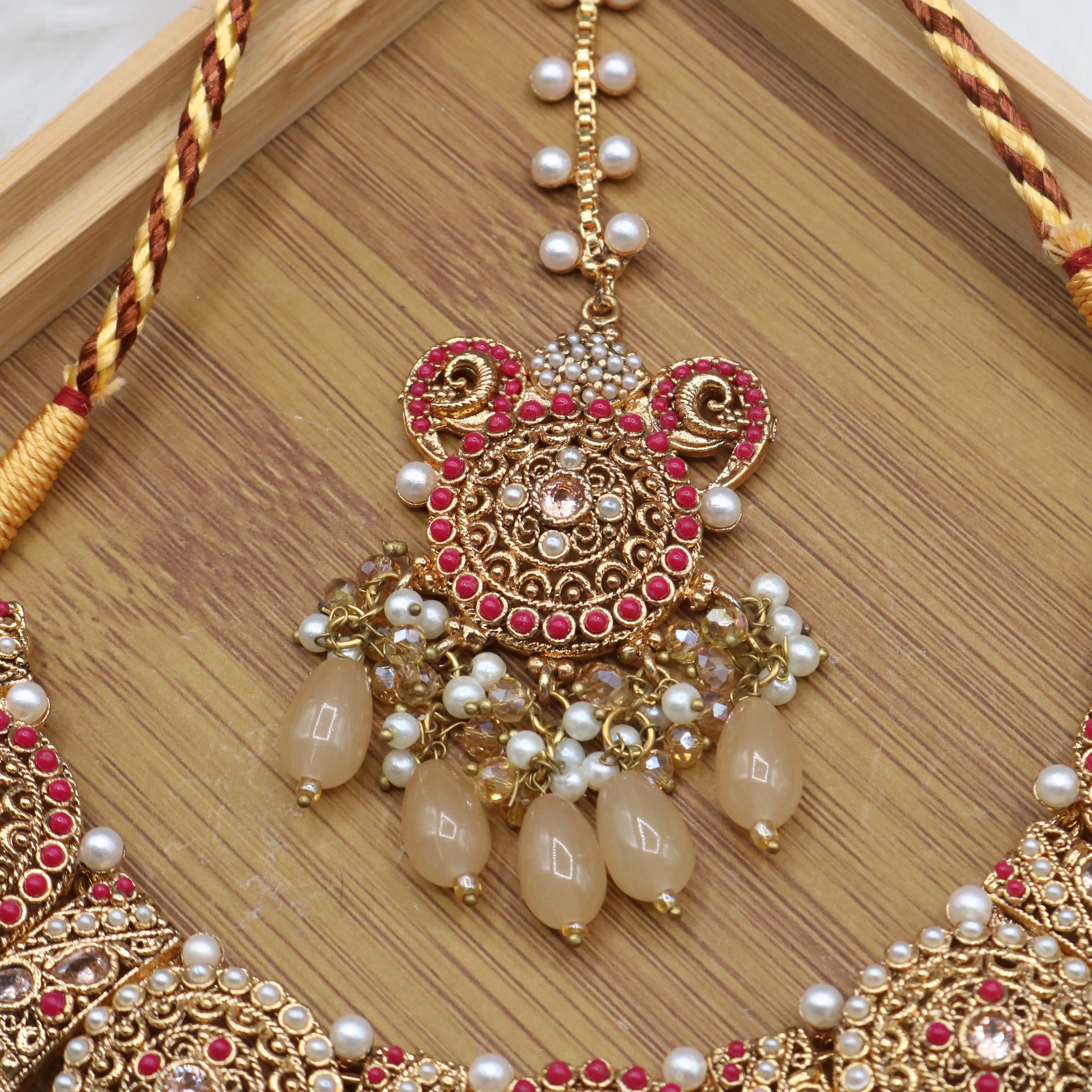 teeka view of Traditional bridal jewelry set with beige stones, pearls and antique gold finish