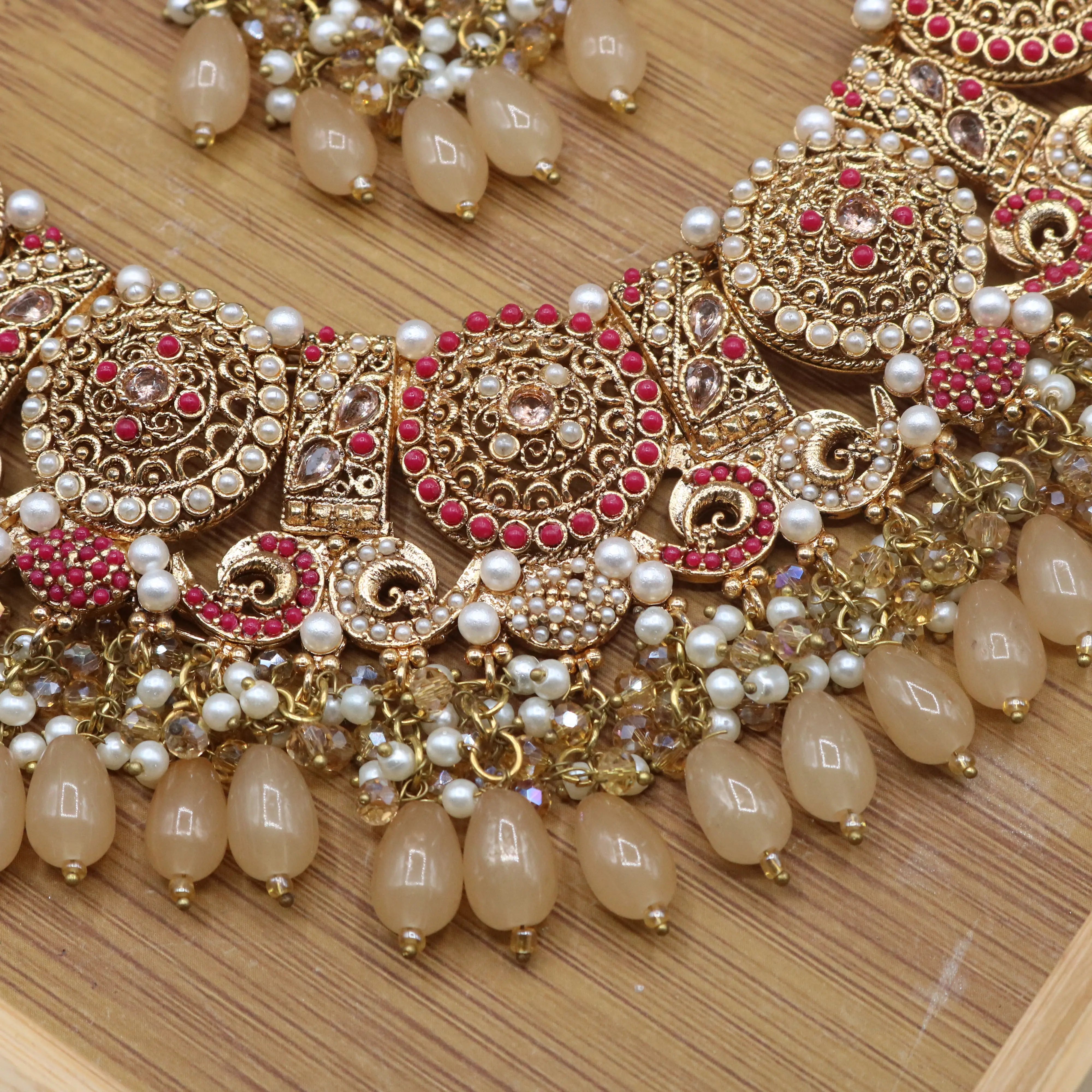 closer necklace view of Traditional bridal jewelry set with beige stones, pearls and antique gold finish