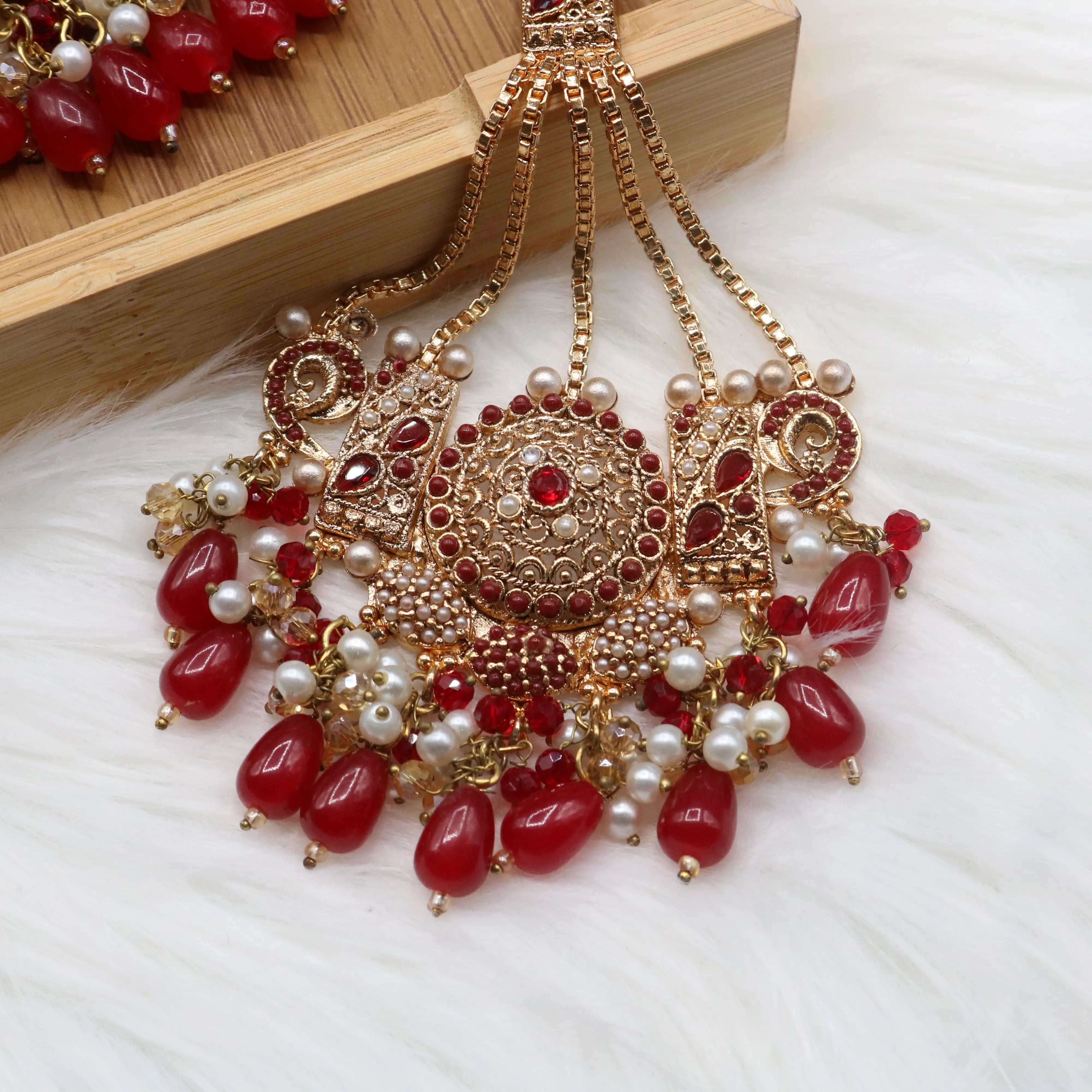 jhoomer view of Pakistani bridal necklace set with earrings, jhoomer and teeka in red and gold