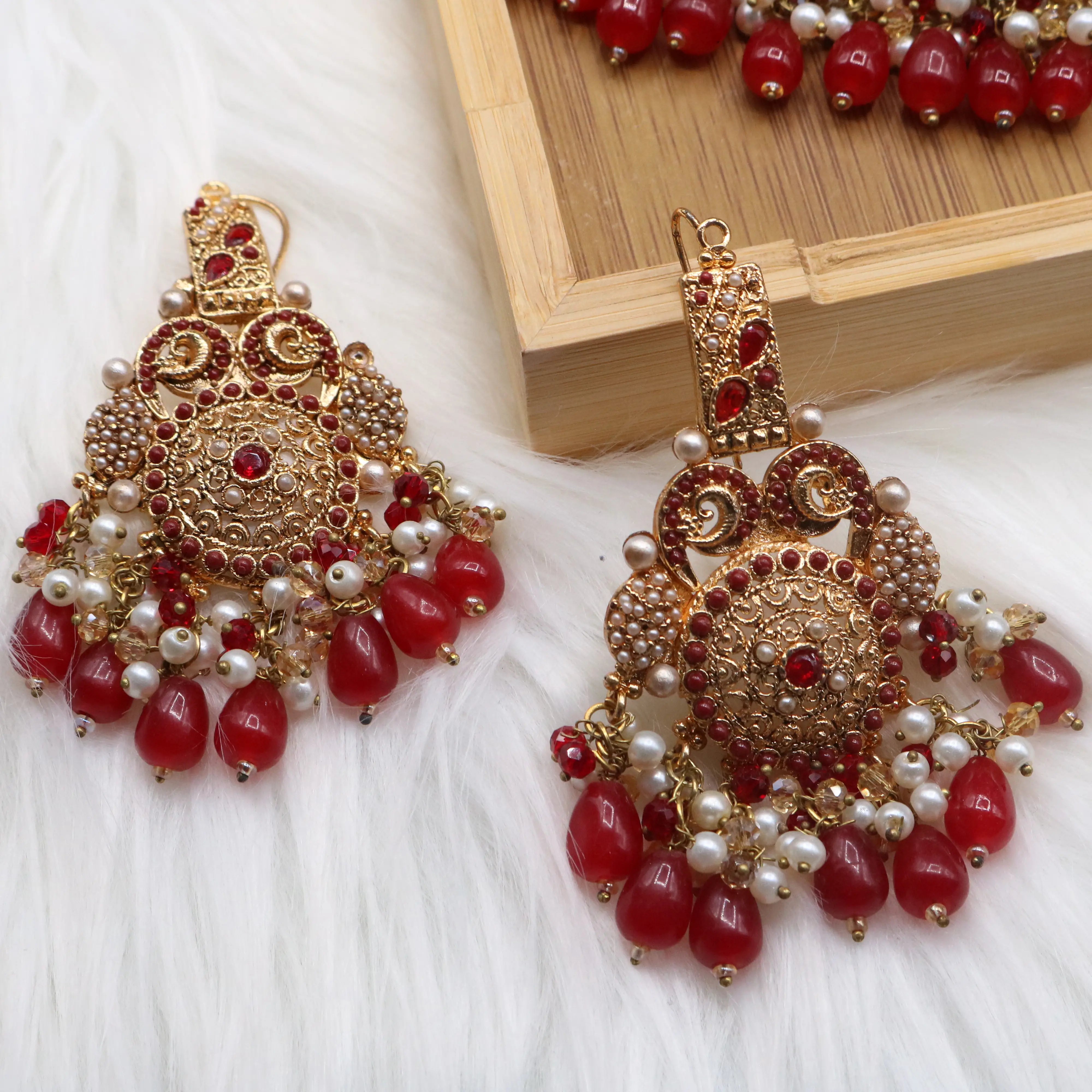 earrings view of Pakistani bridal necklace set with earrings, jhoomer and teeka in red and gold