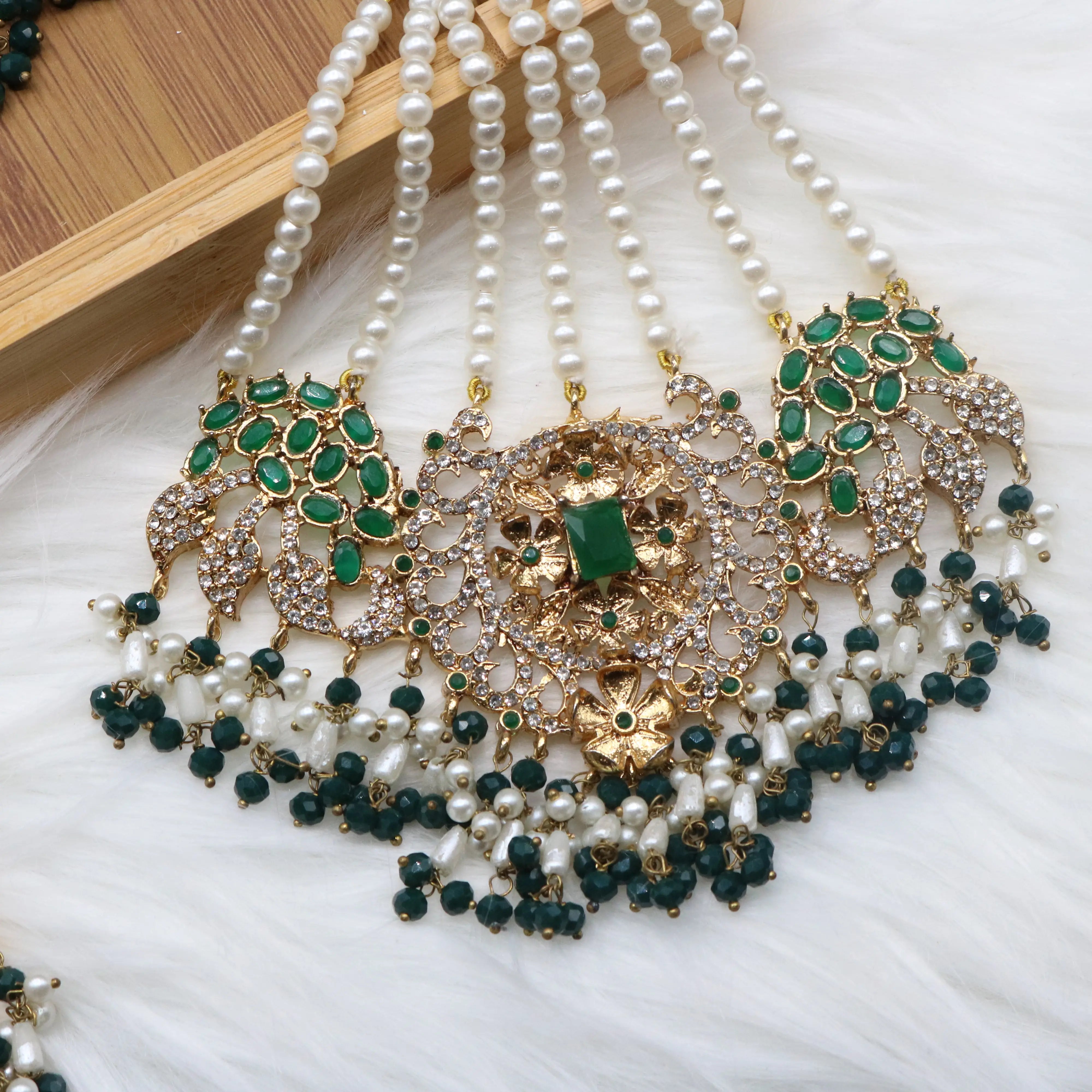 jhoomer view of Pakistani bridal necklace set with earrings, jhoomer and teeka in green and gold with pearls