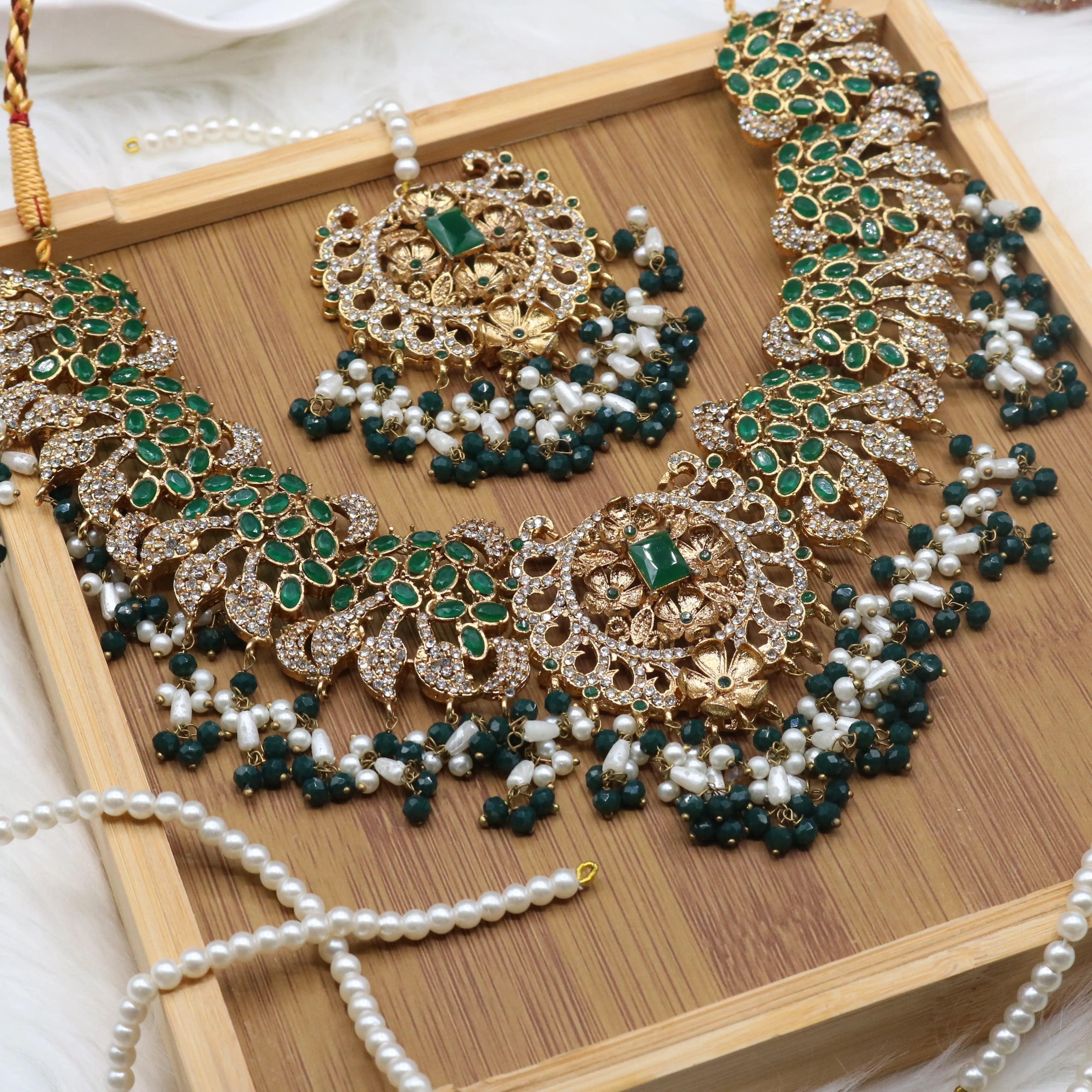 necklace and teeka view of Pakistani bridal necklace set with earrings, jhoomer and teeka in green and gold with pearls