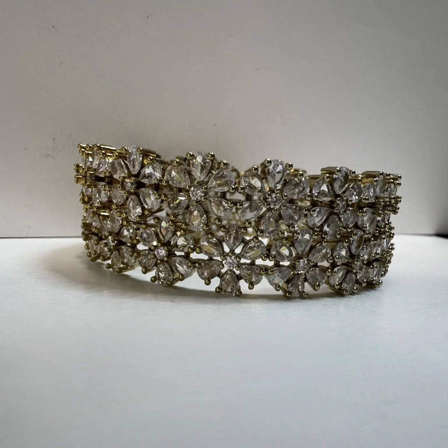 24k gold plated floral pattern bangle set with antique polish for a lasting shine on a white background