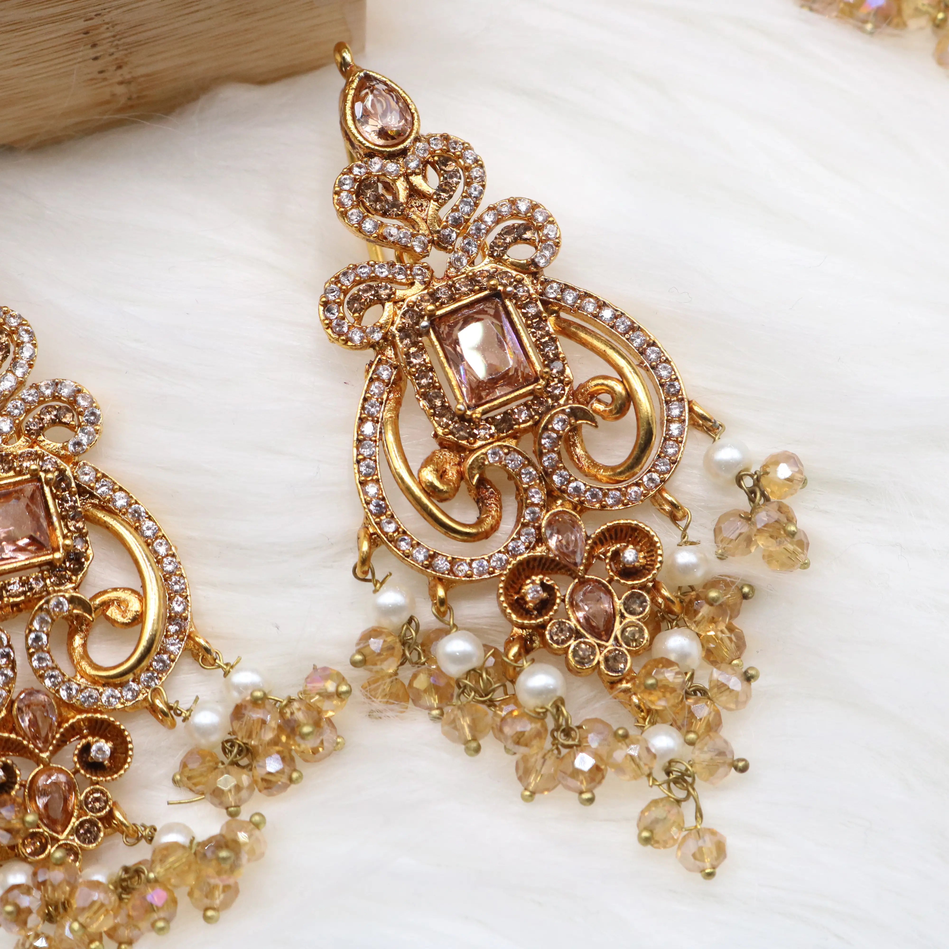 more closer earring view of Champagne gold bridal necklace set with earrings, teeka & jhoomer in stainless steel