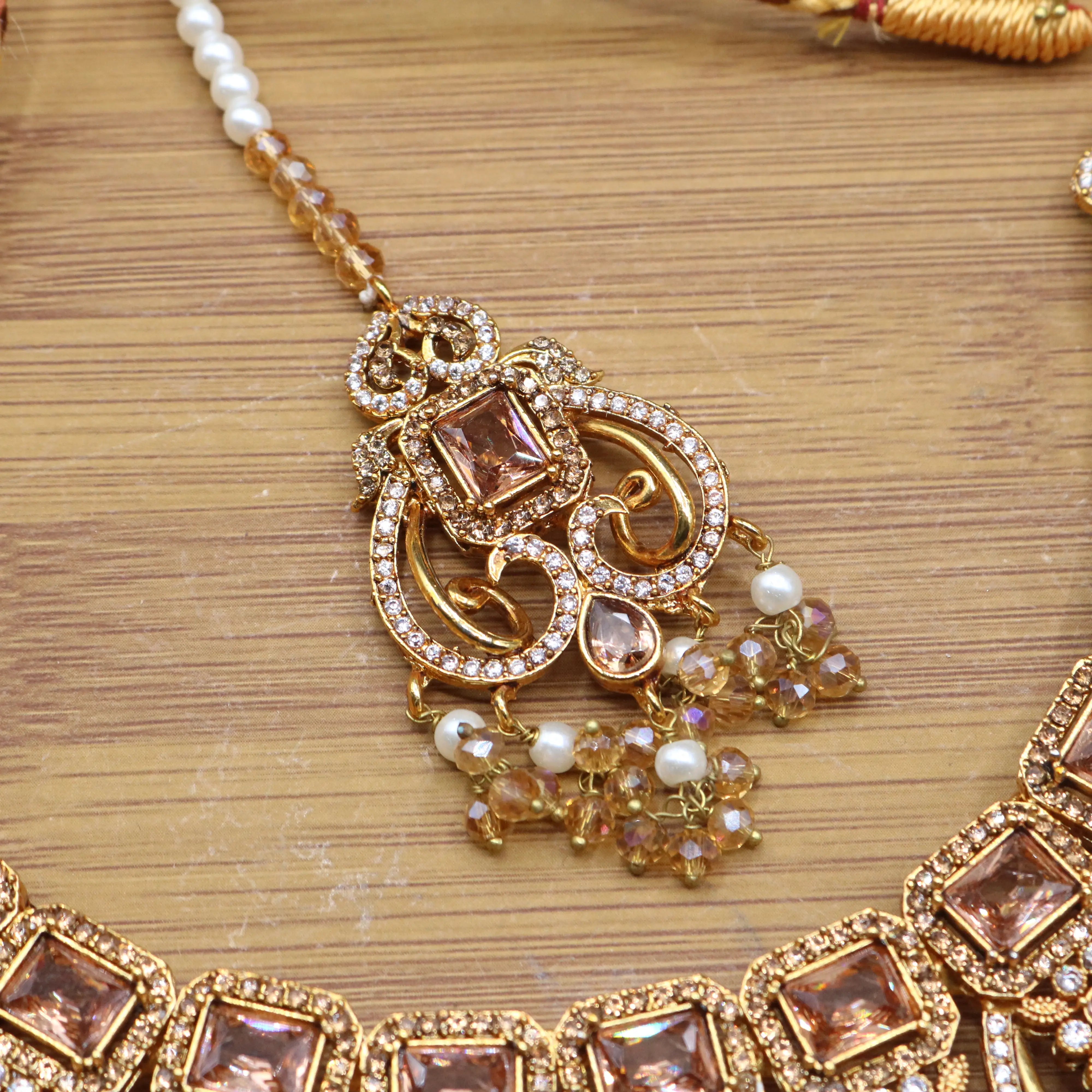 teeka view of Champagne gold bridal necklace set with earrings, teeka & jhoomer in stainless steel