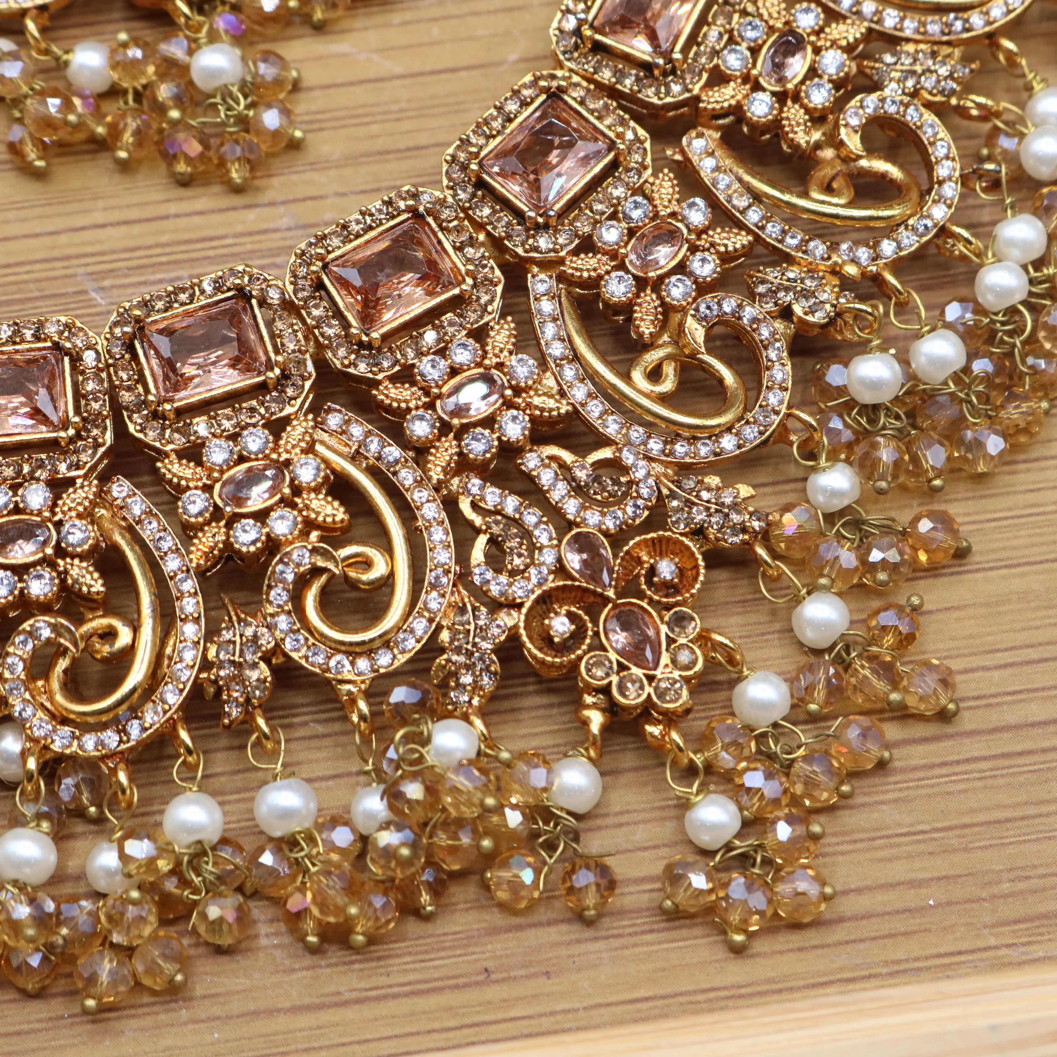 more closer necklace view of Champagne gold bridal necklace set with earrings, teeka & jhoomer in stainless steel