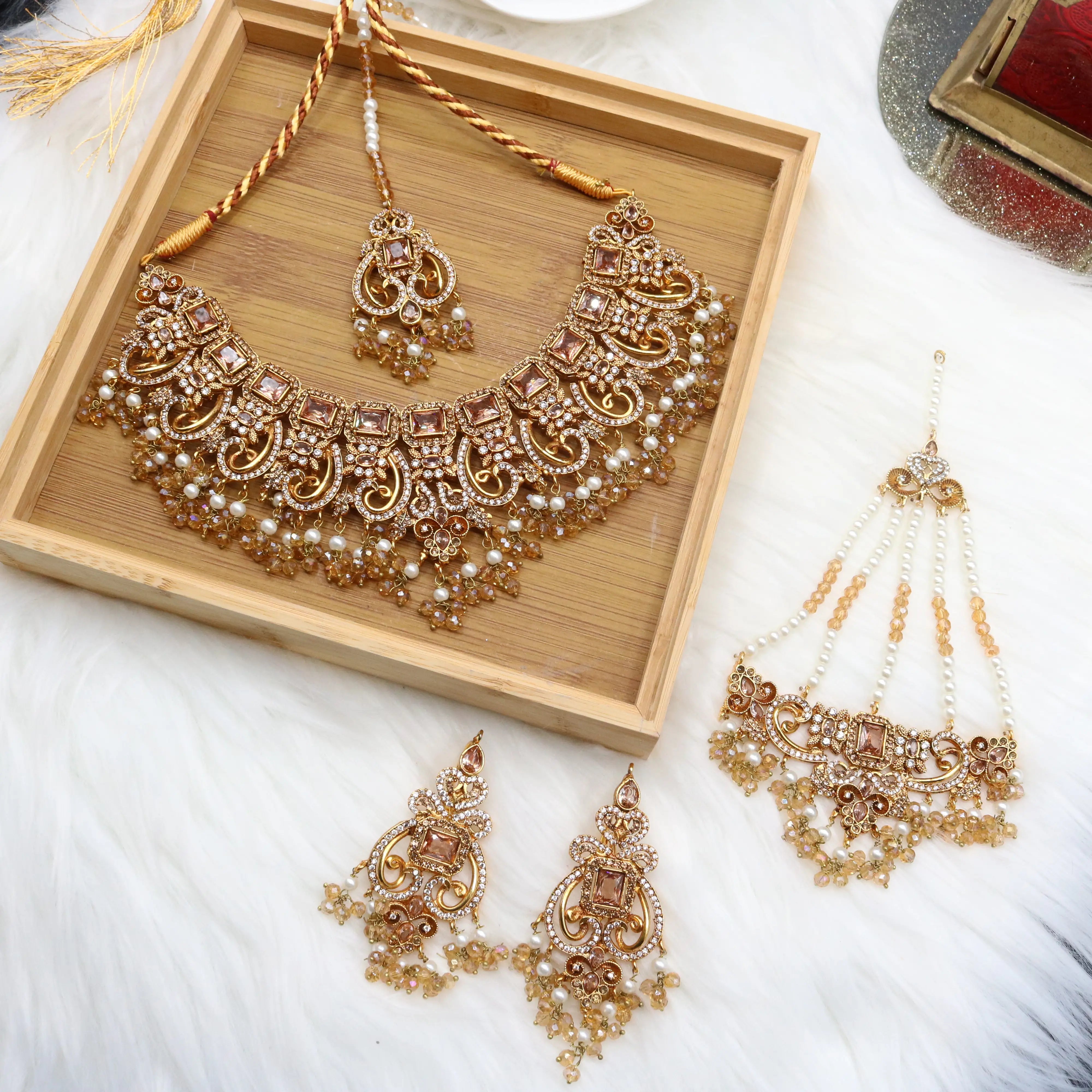 closer view of Champagne gold bridal necklace set with earrings, teeka & jhoomer in stainless steel