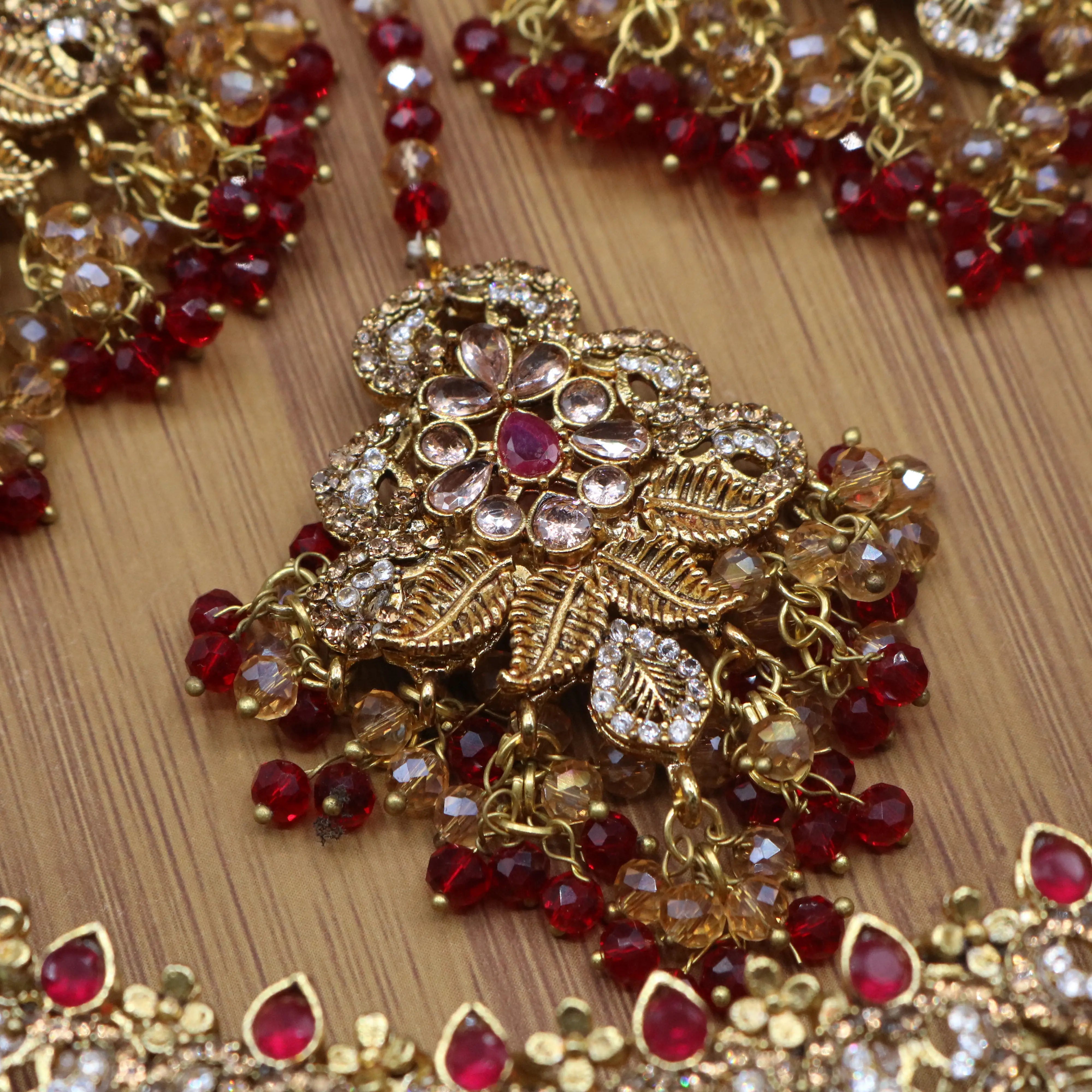 teeka view of Red floral bridal necklace set with earrings, teeka & jhoomer in stainless steel