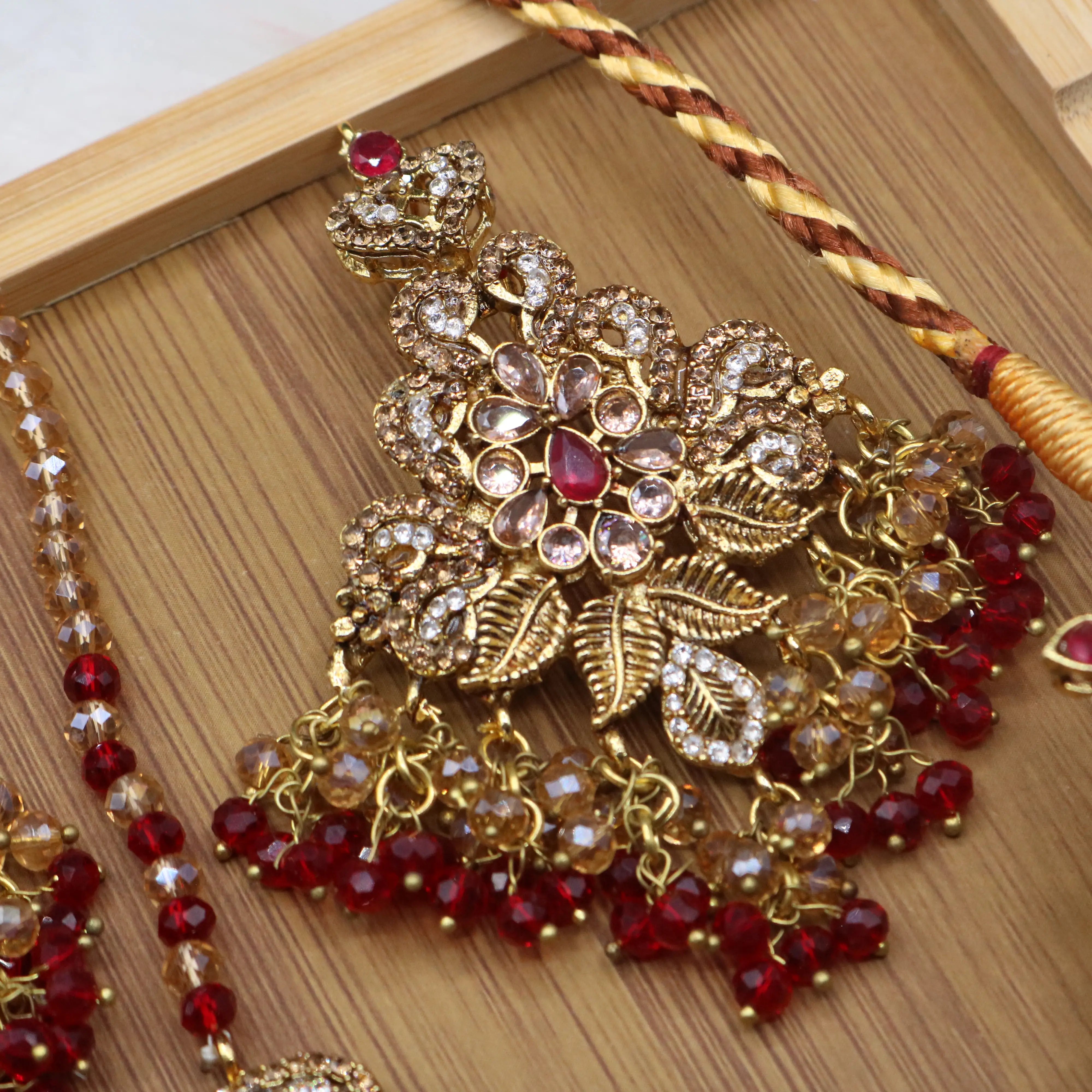 earring view of Red floral bridal necklace set with earrings, teeka & jhoomer in stainless steel