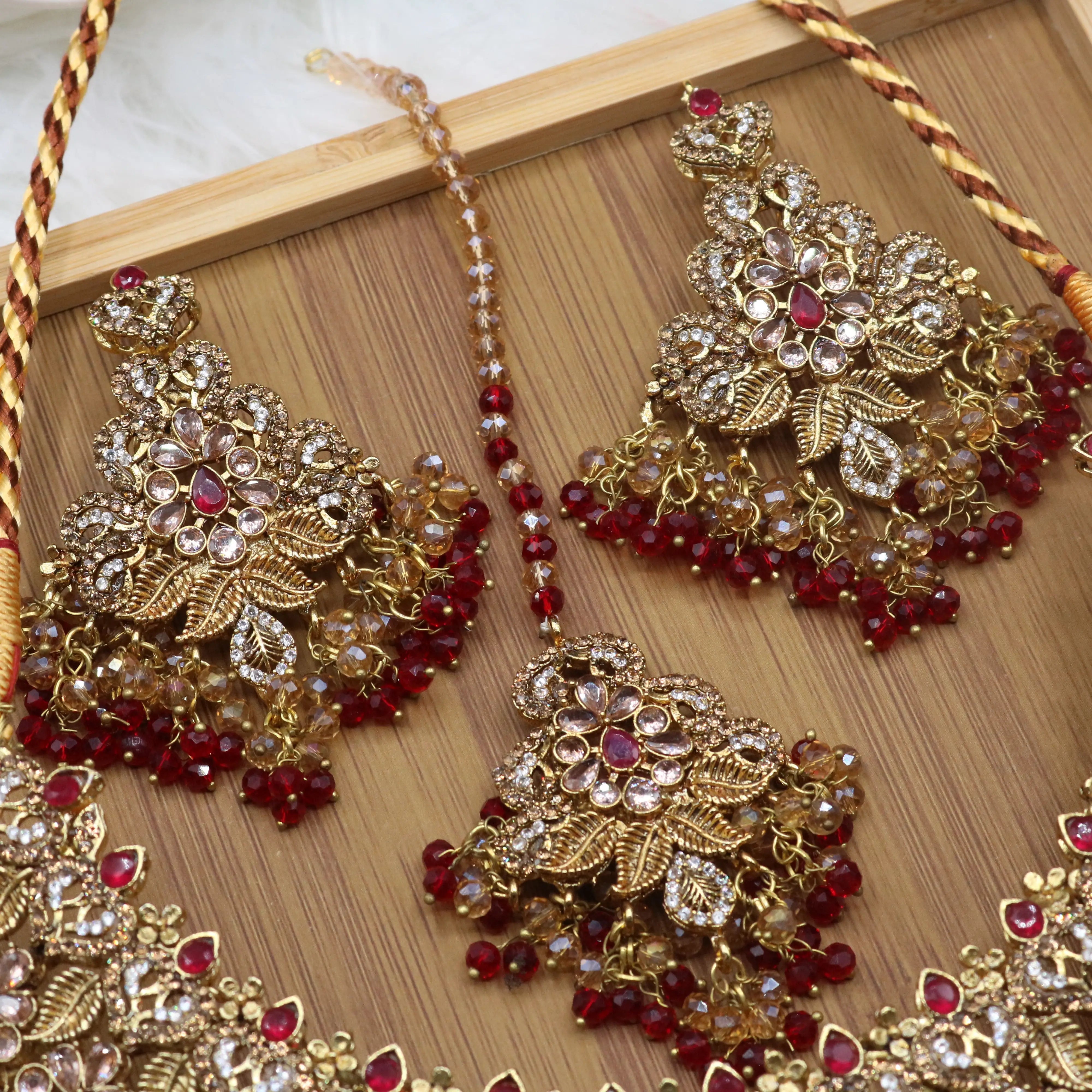 earrings and teeka view of Red floral bridal necklace set with earrings, teeka & jhoomer in stainless steel