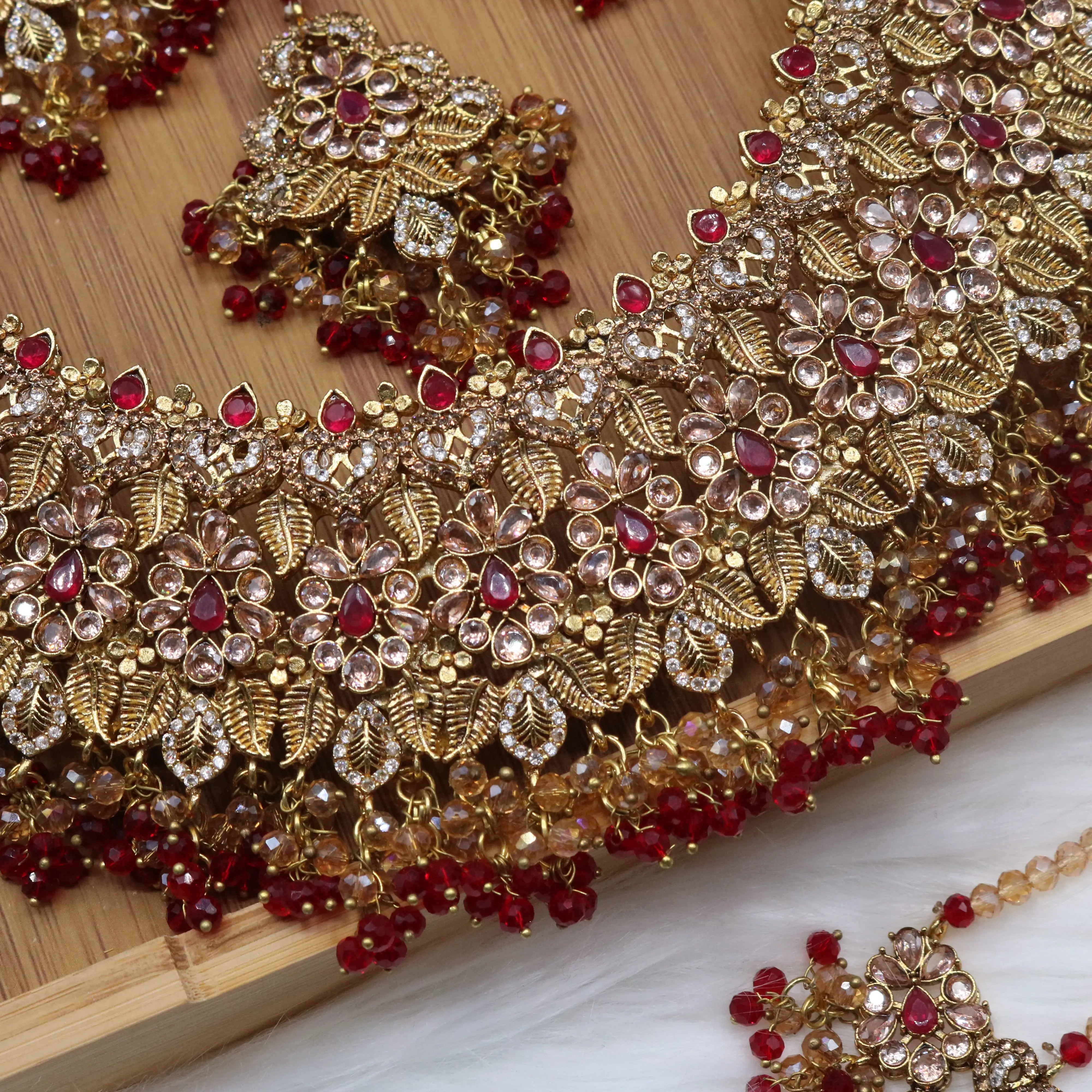 necklace view Red floral bridal necklace set with earrings, teeka & jhoomer in stainless steel