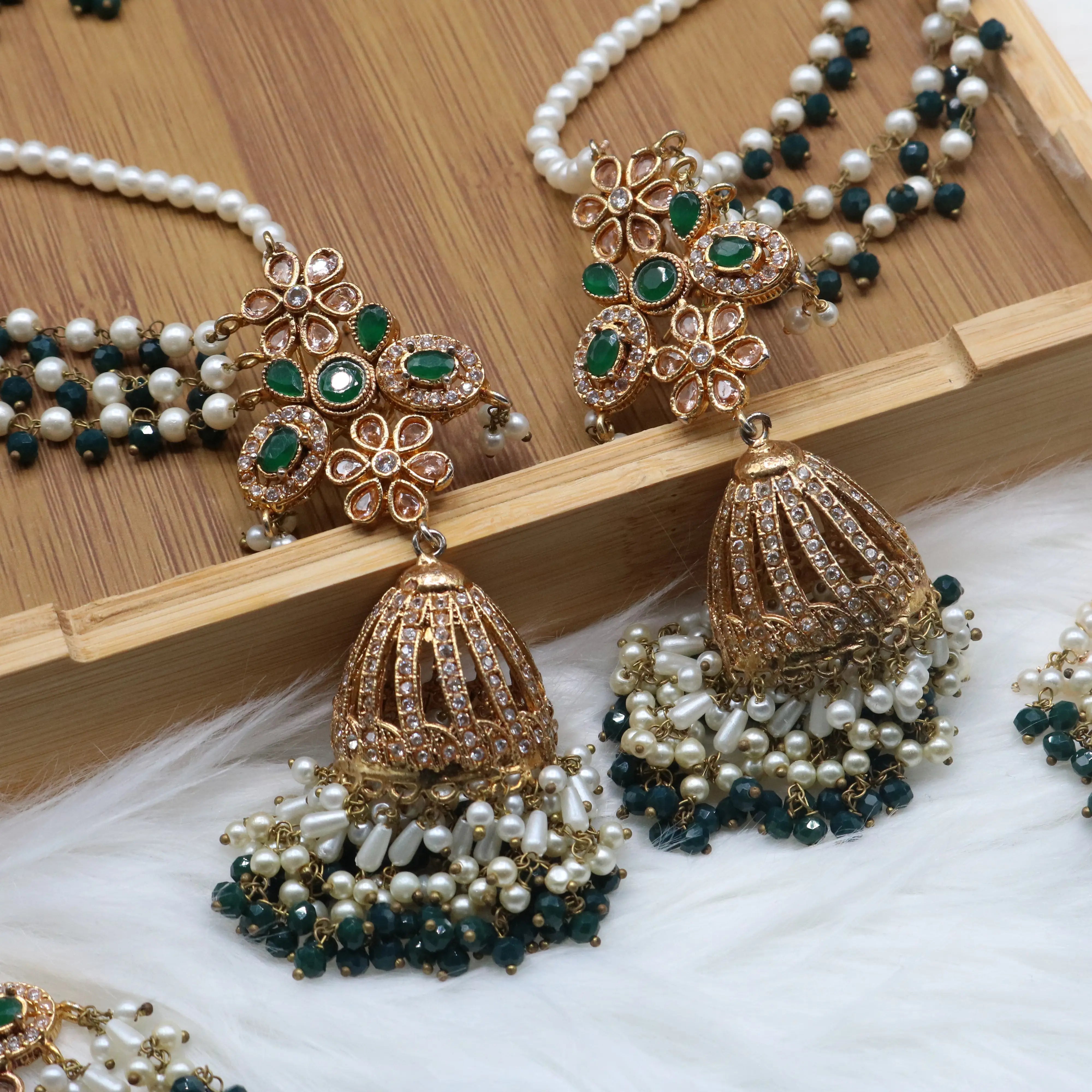 jhumka closer view of Emerald bridal choker necklace with jhumka sahara earrings, teeka & jhoomer