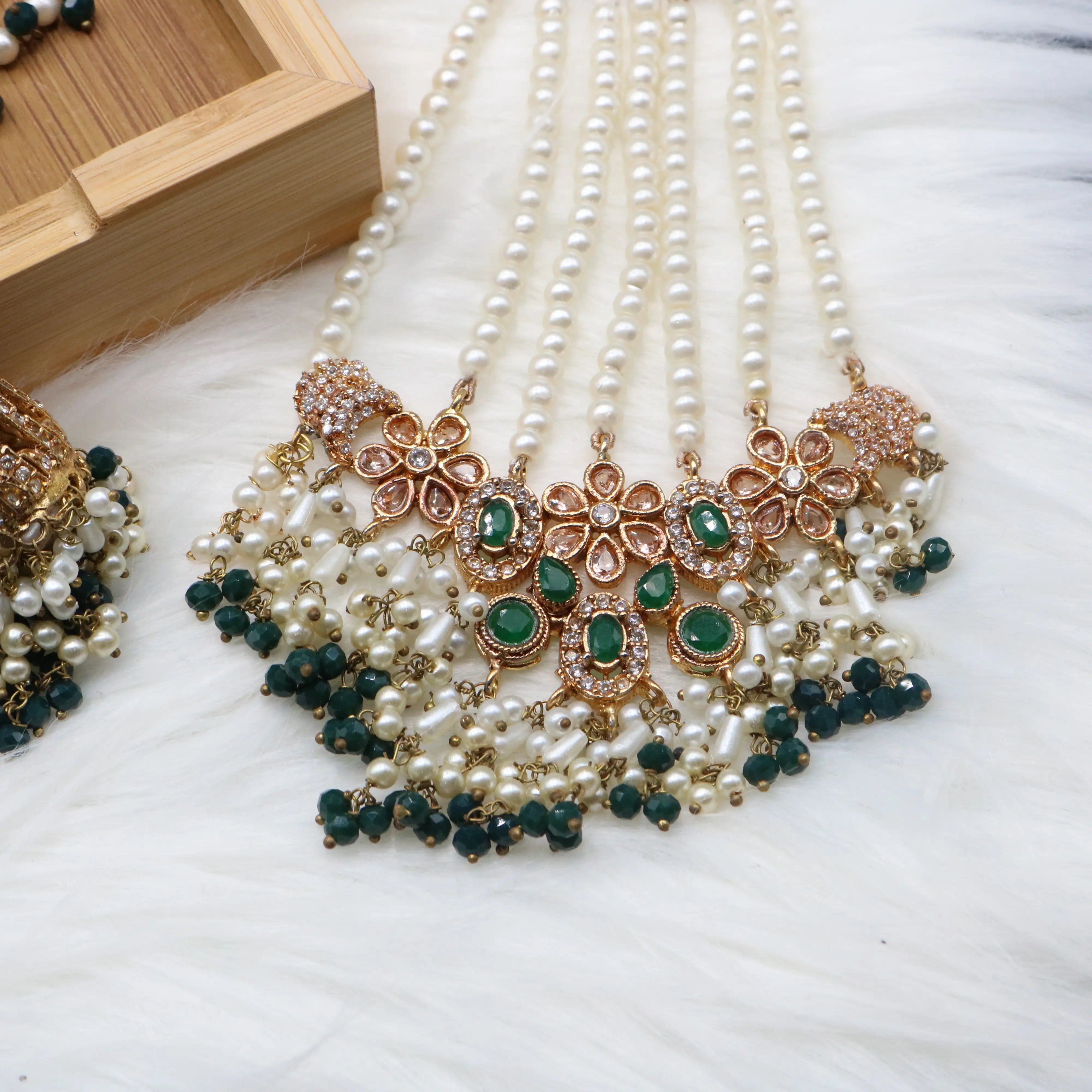 closer jhoomer view of Emerald bridal choker necklace with jhumka sahara earrings, teeka & jhoomer