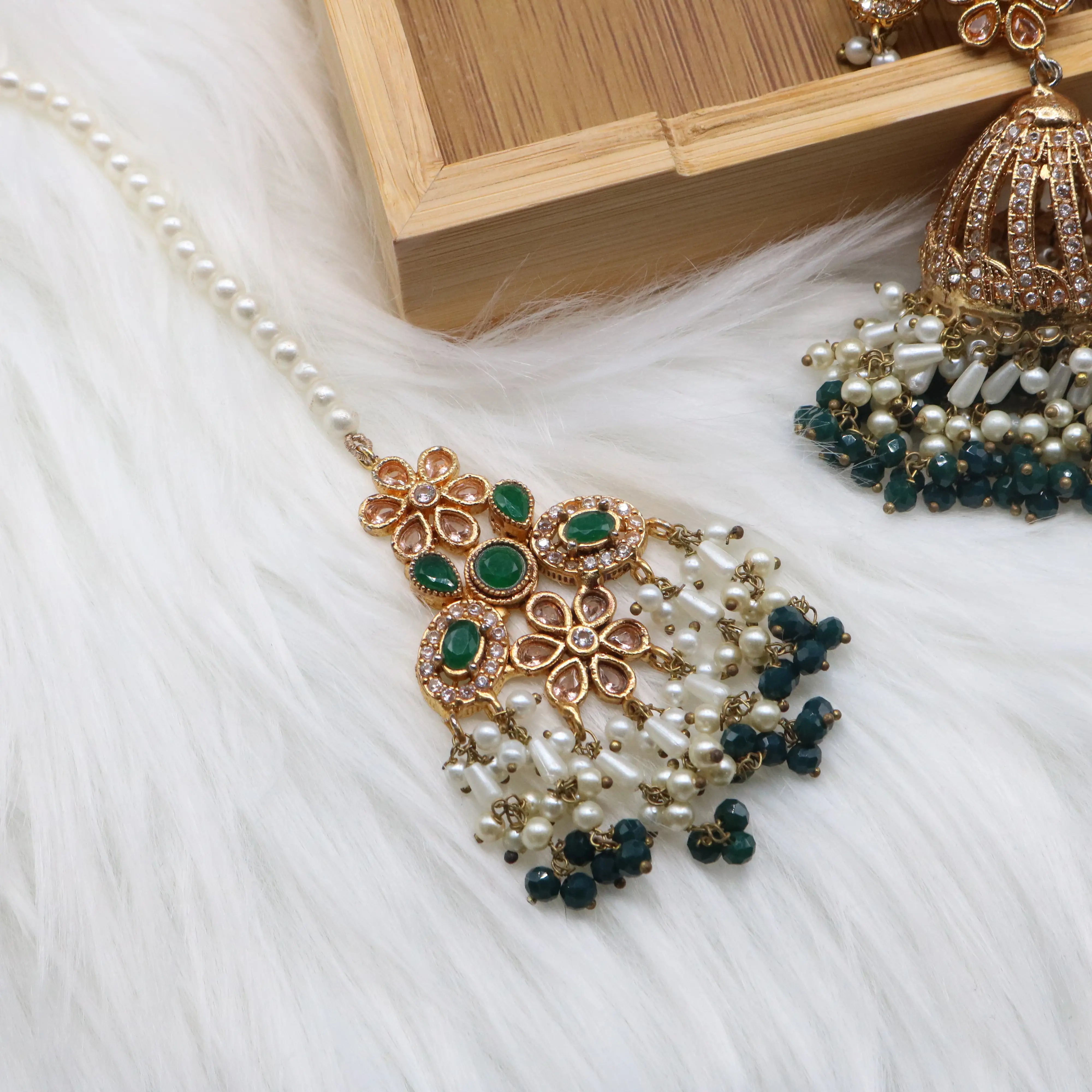 teeka view of Emerald bridal choker necklace with jhumka sahara earrings, teeka & jhoomer