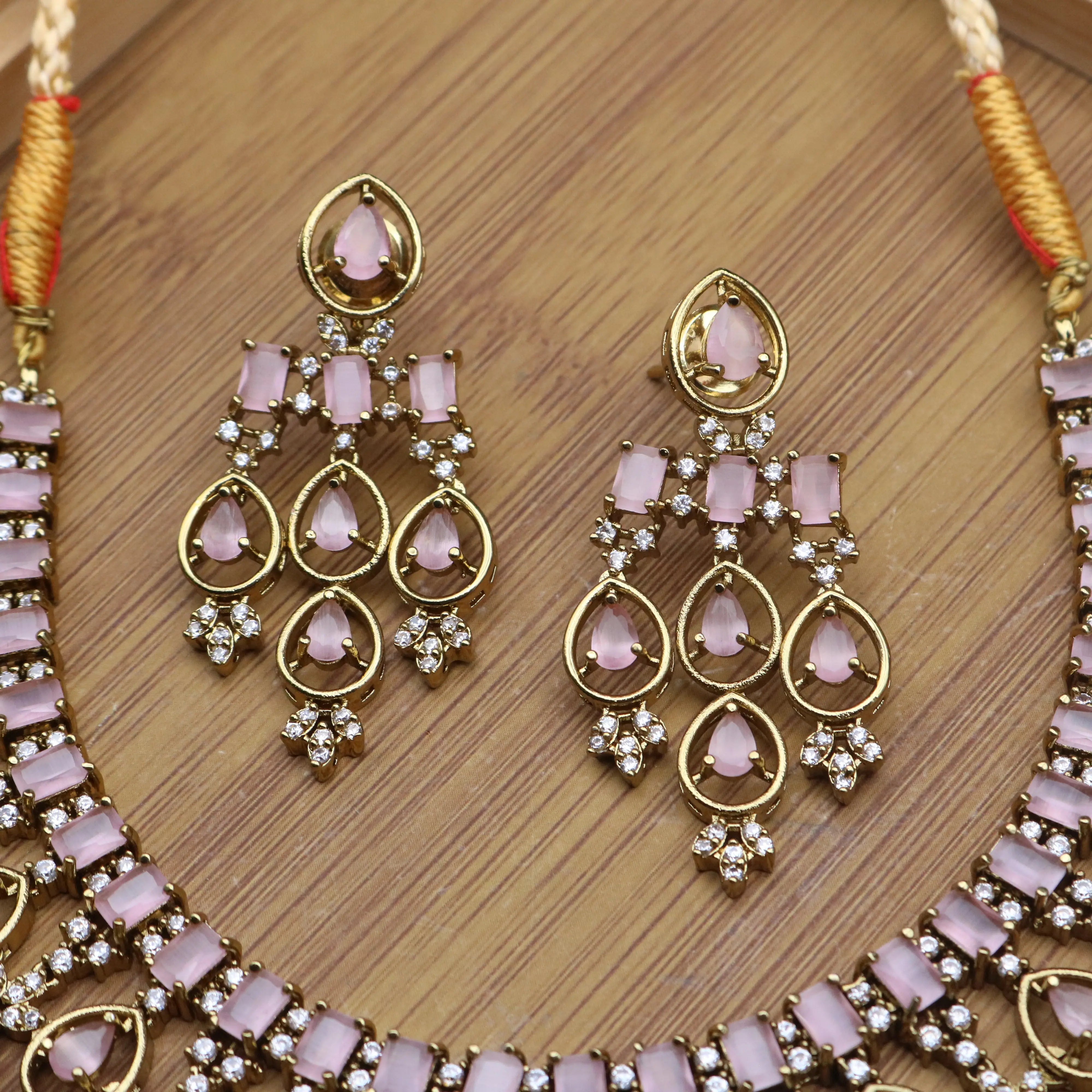 earrings view of Partywear necklace set with pink stones and American diamonds