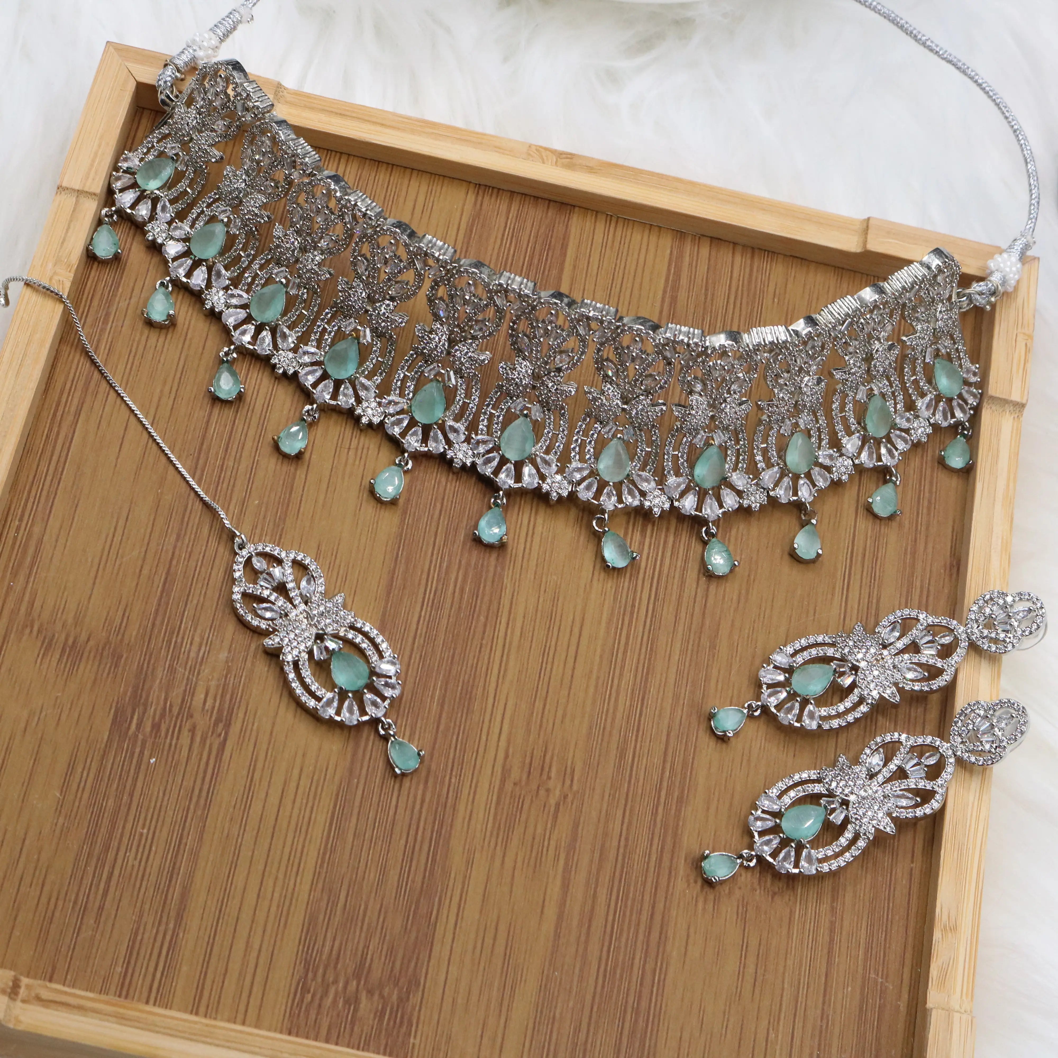 Silver finish partywear jewelry set with American diamonds and teal gemstones
