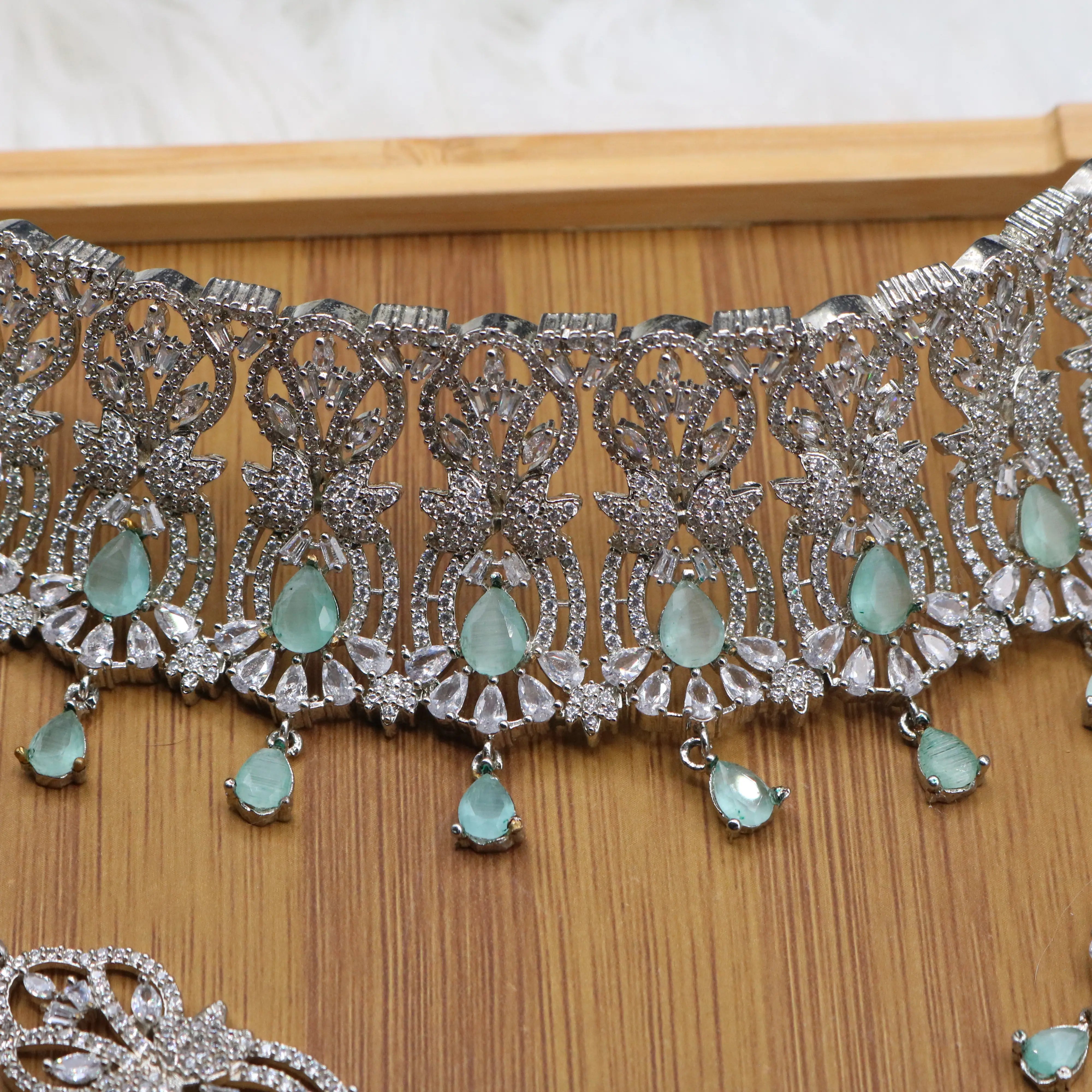 necklace view of Silver finish partywear jewelry set with American diamonds and teal gemstones