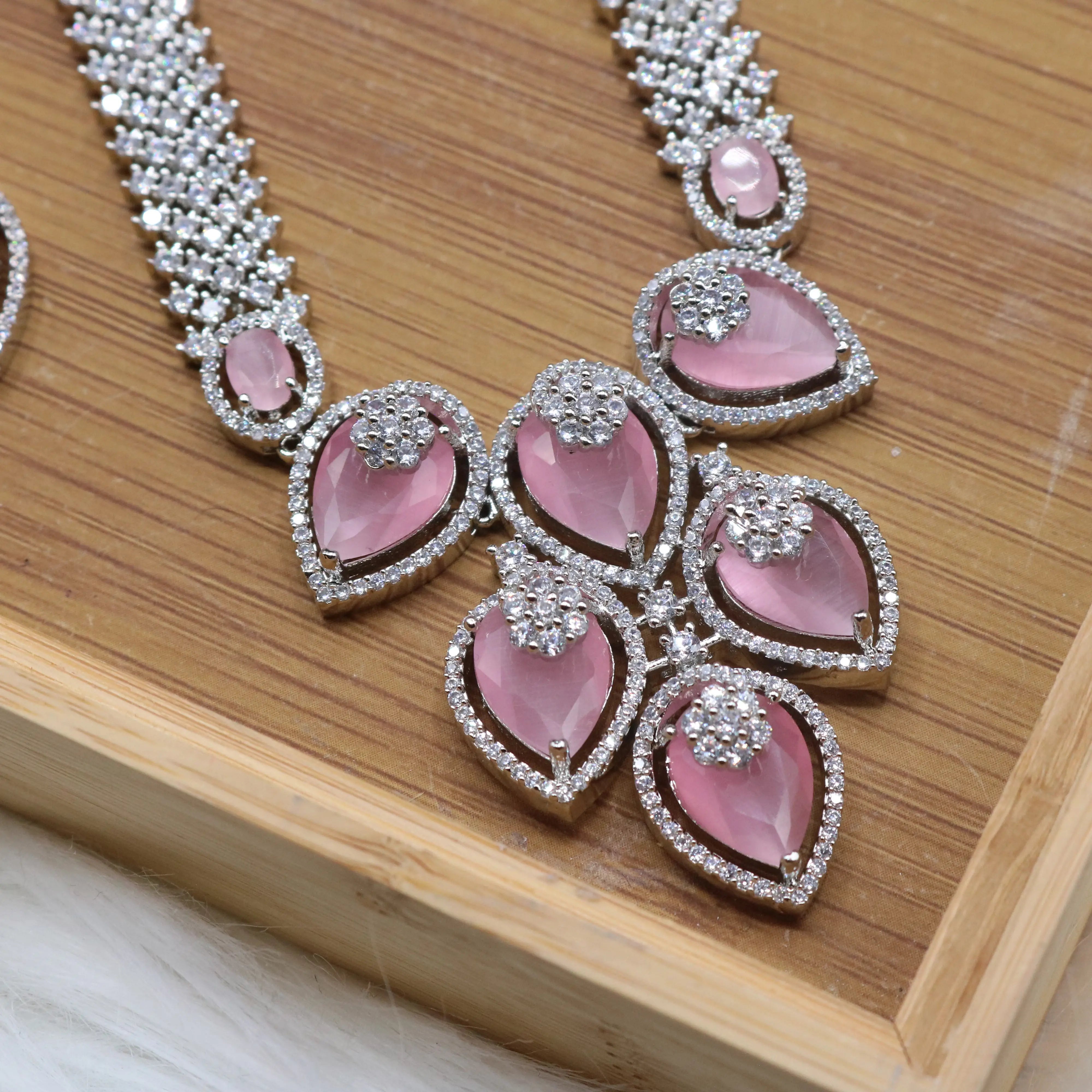 closer pendant view of Silver and pink long bridal necklace set with earrings and teeka