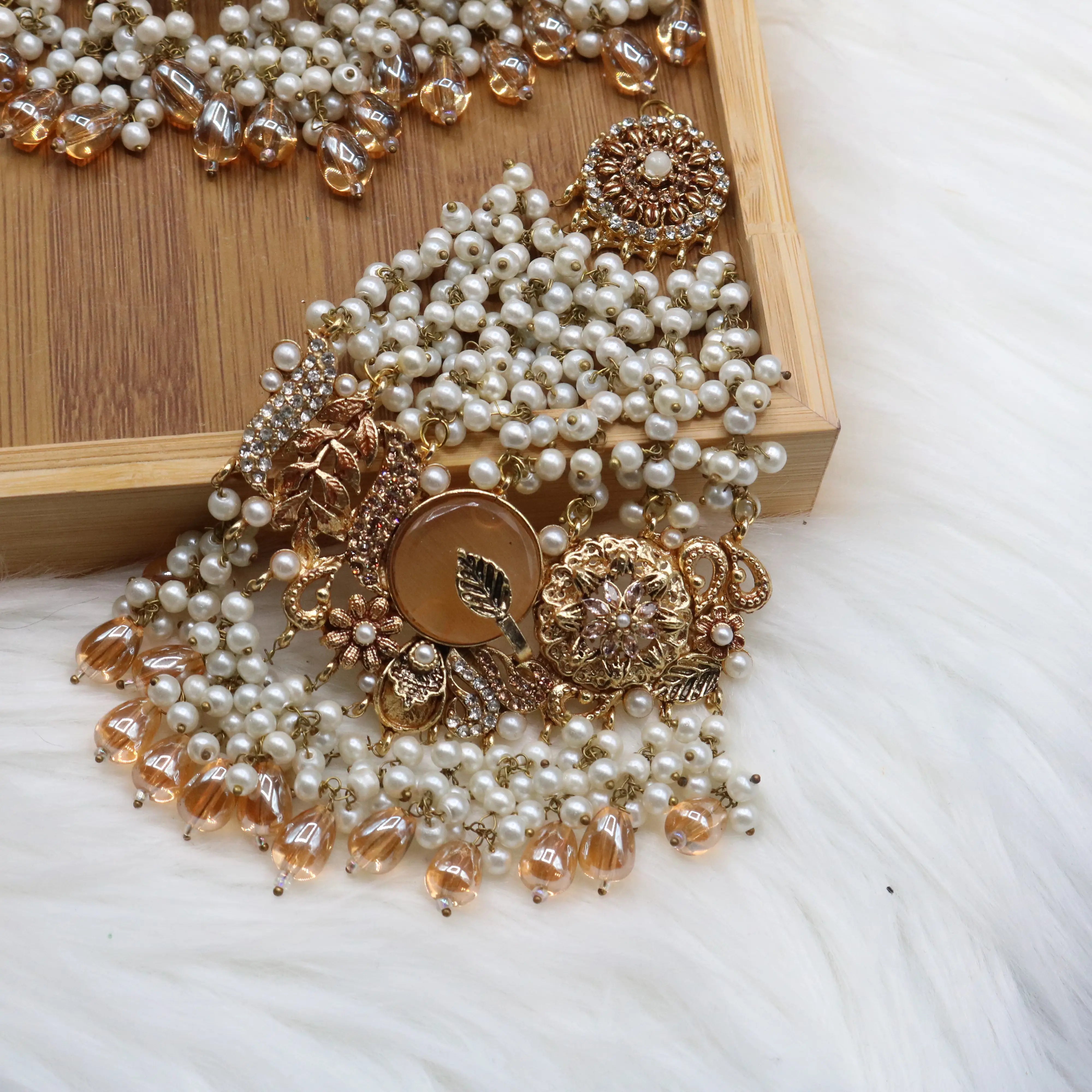 another angle of jhoomer view of Gold pearl and champagne Pakistani bridal choker set with jhoomer