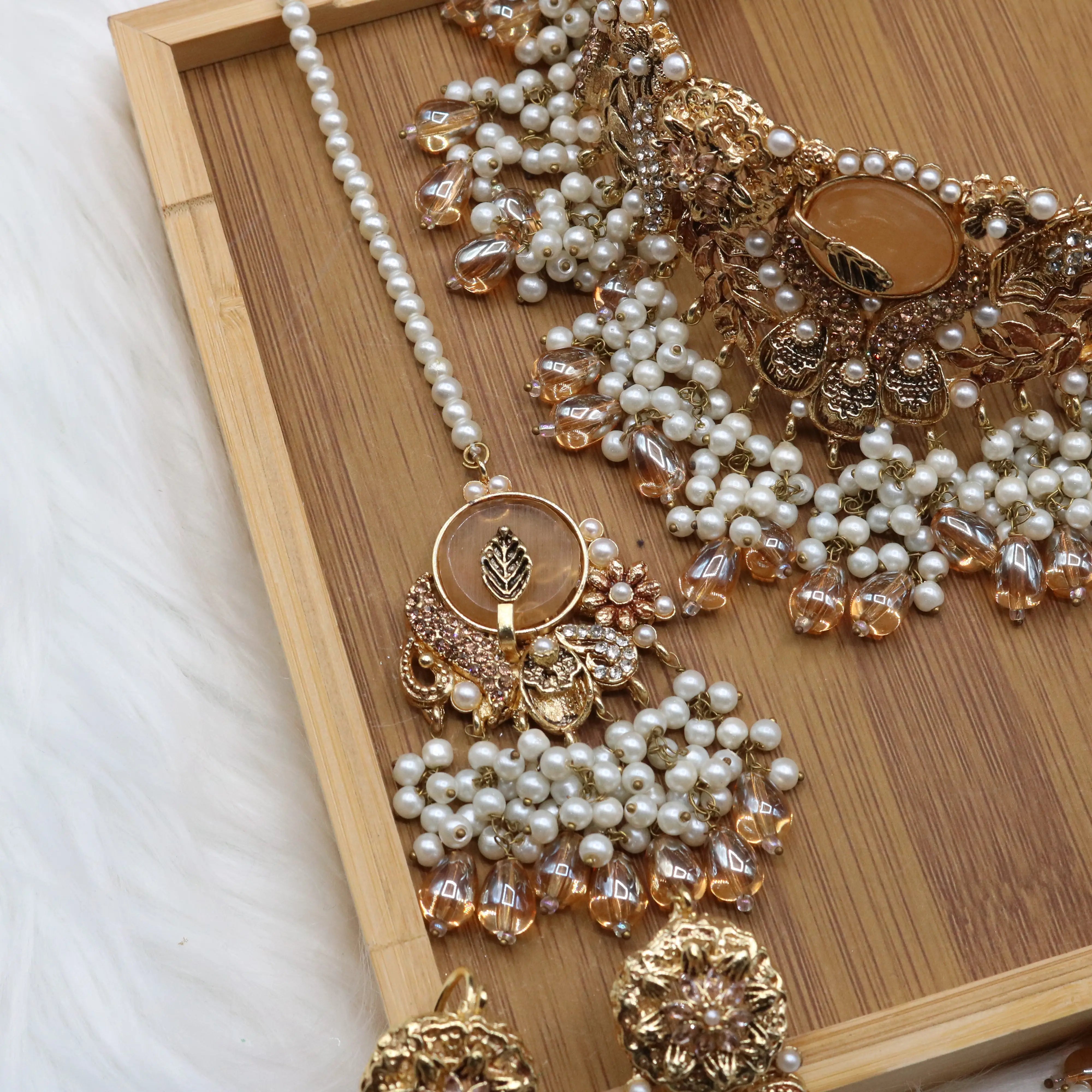 teeka view of Gold pearl and champagne Pakistani bridal choker set with jhoomer