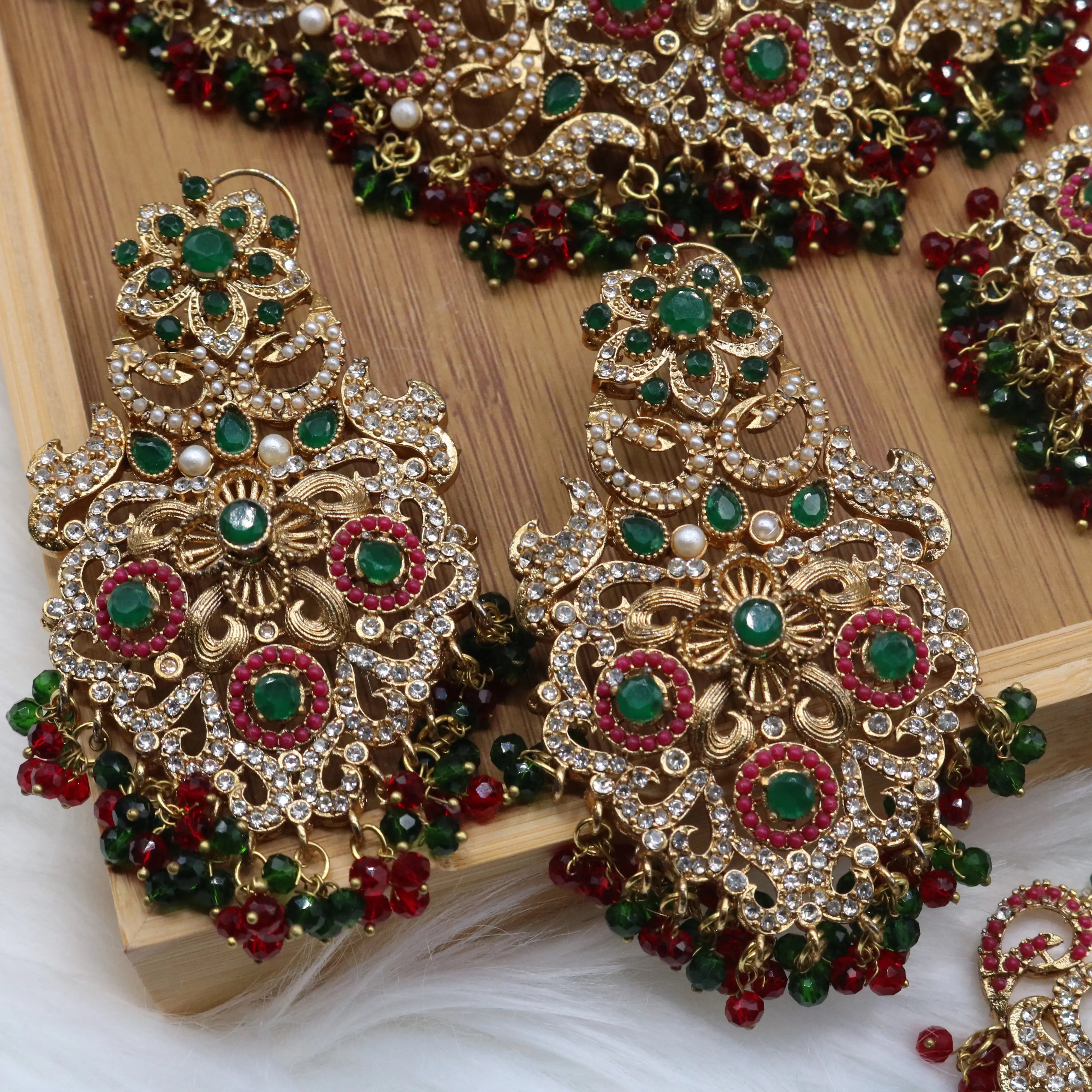 earrings closer view of Pakistani bridal choker jewelry with emerald and ruby stones