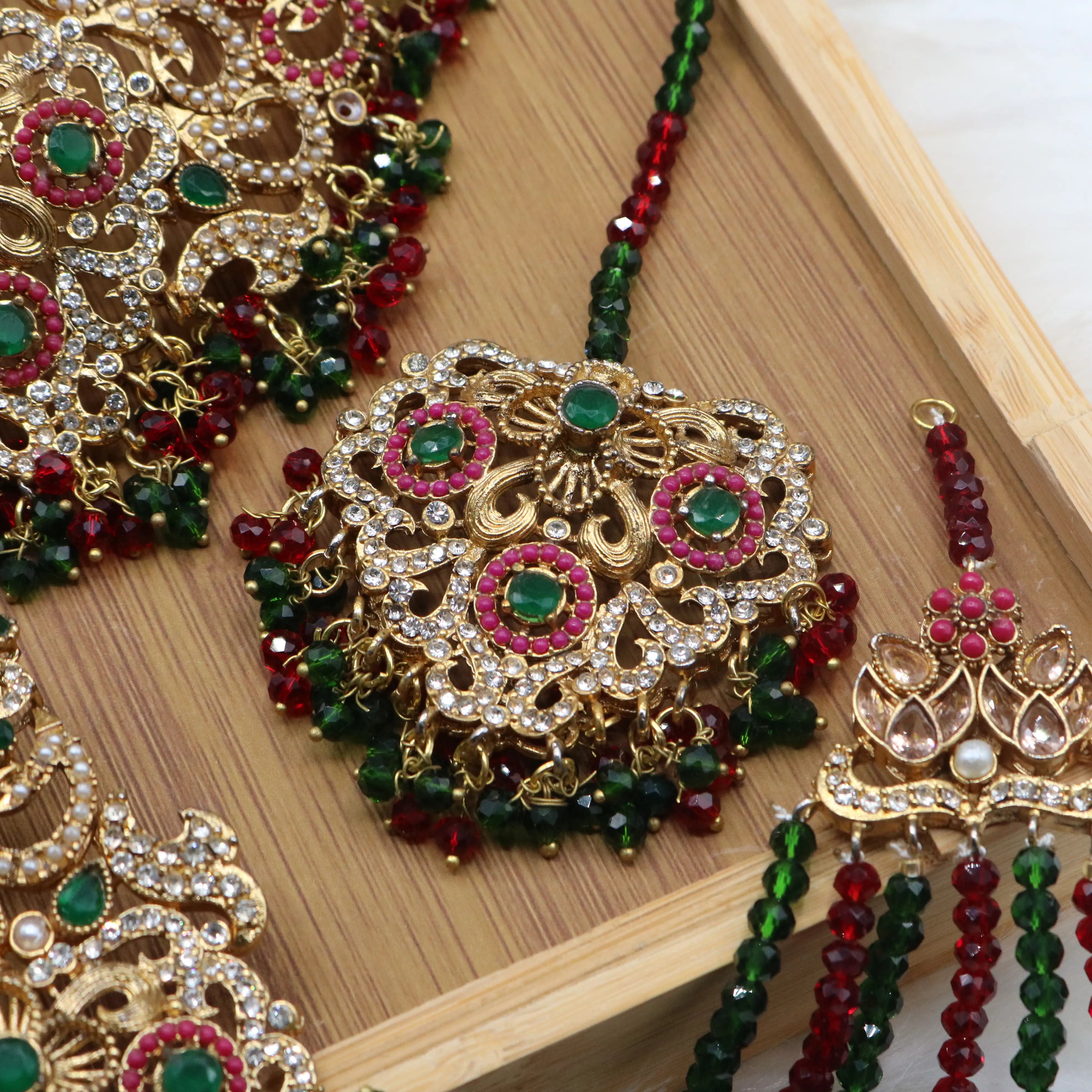 teeka closer view of Pakistani bridal choker jewelry with emerald and ruby stones
