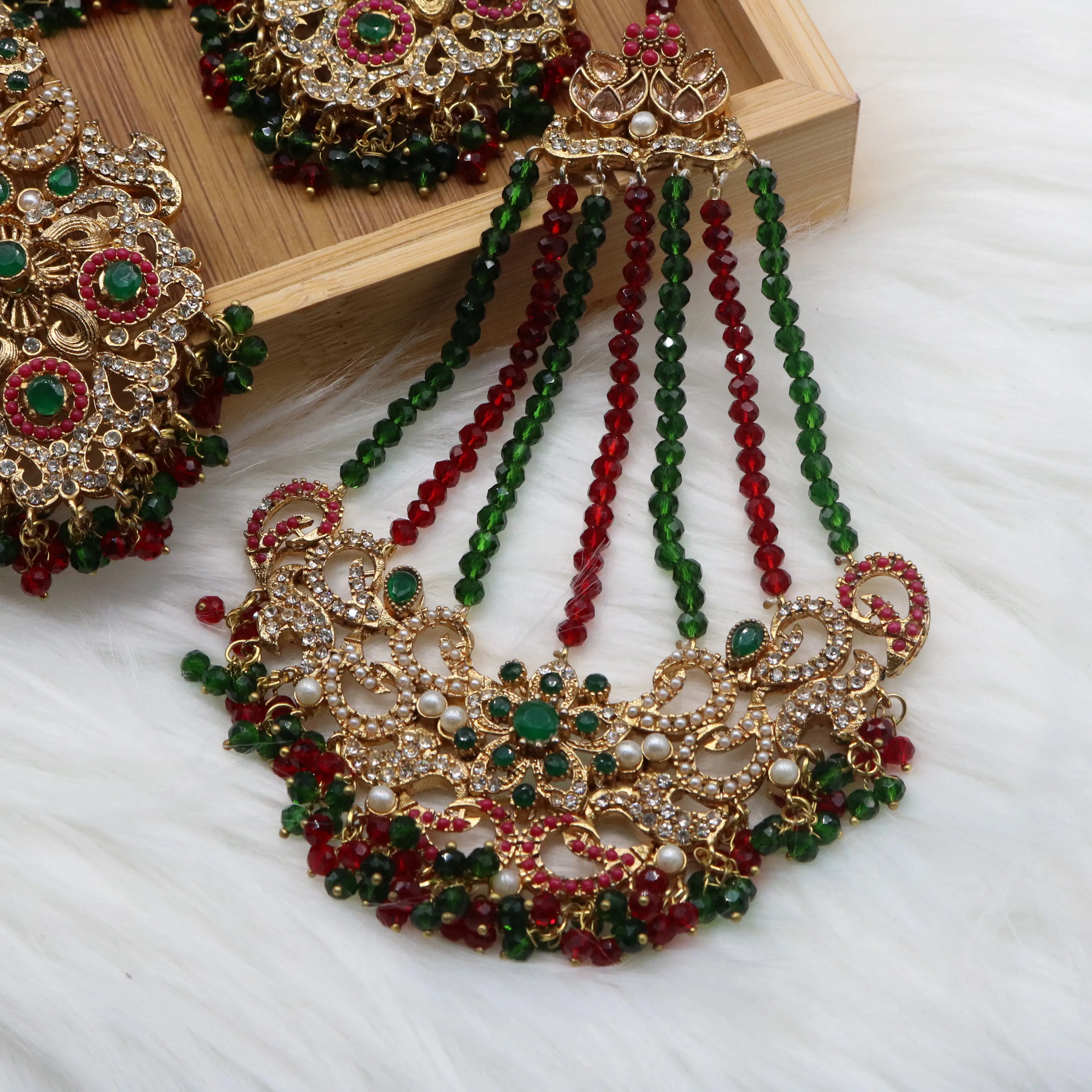 jhoomer closer view of Pakistani bridal choker jewelry with emerald and ruby stones