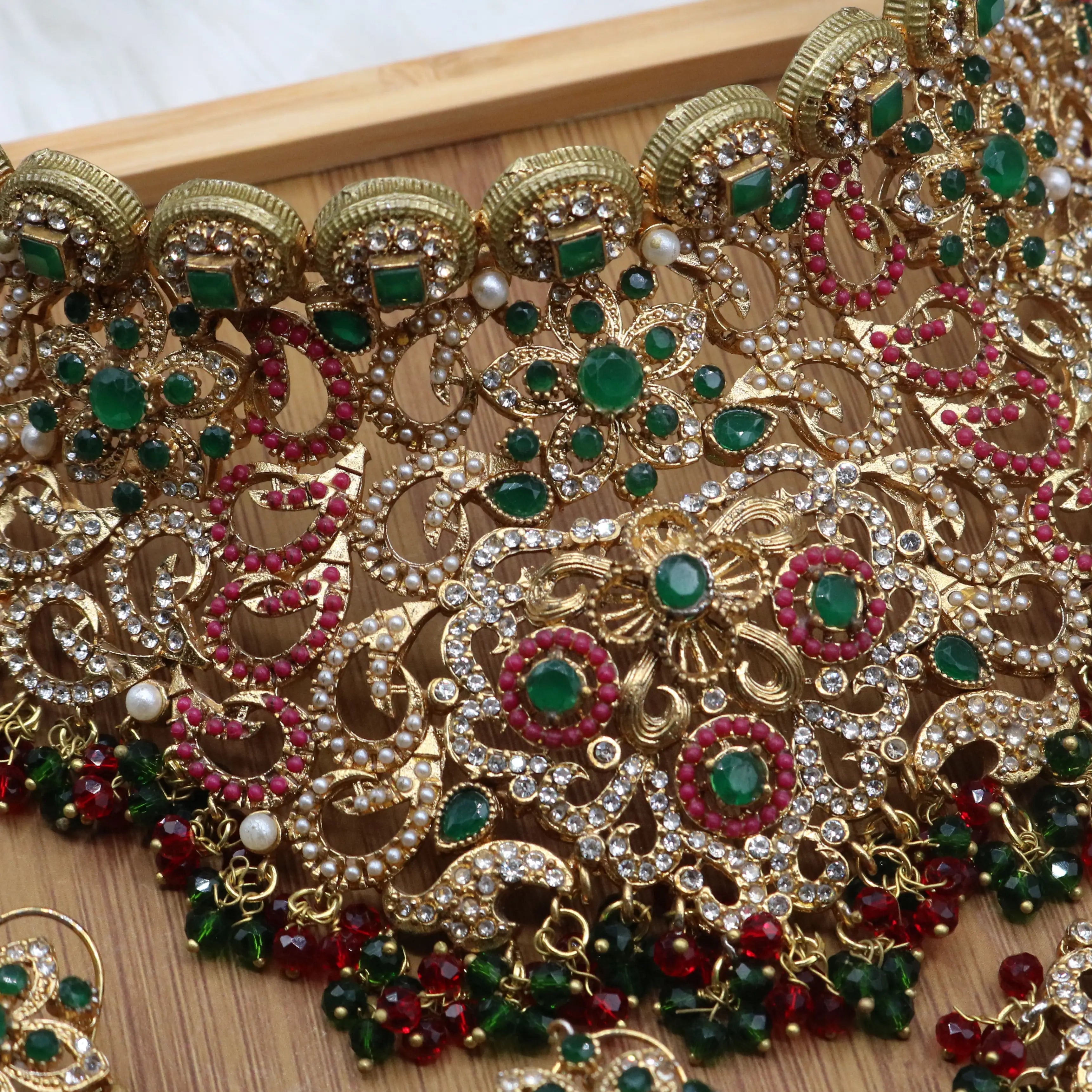 necklace closer view of Pakistani bridal choker jewelry with emerald and ruby stones