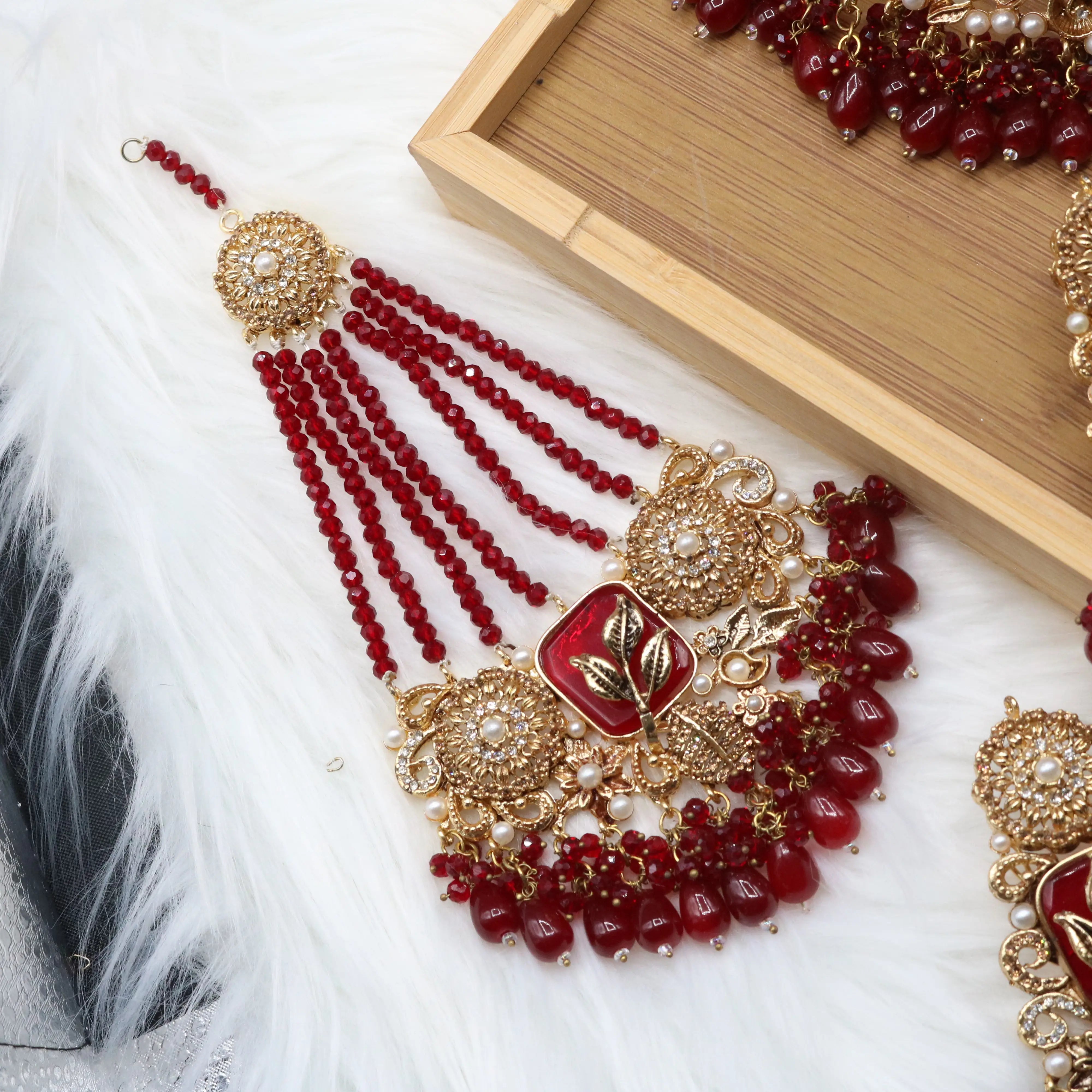 jhoomer view of Red Pakistani bridal choker necklace with matching mala set. Gold-plated bridal set with American diamonds and red stones