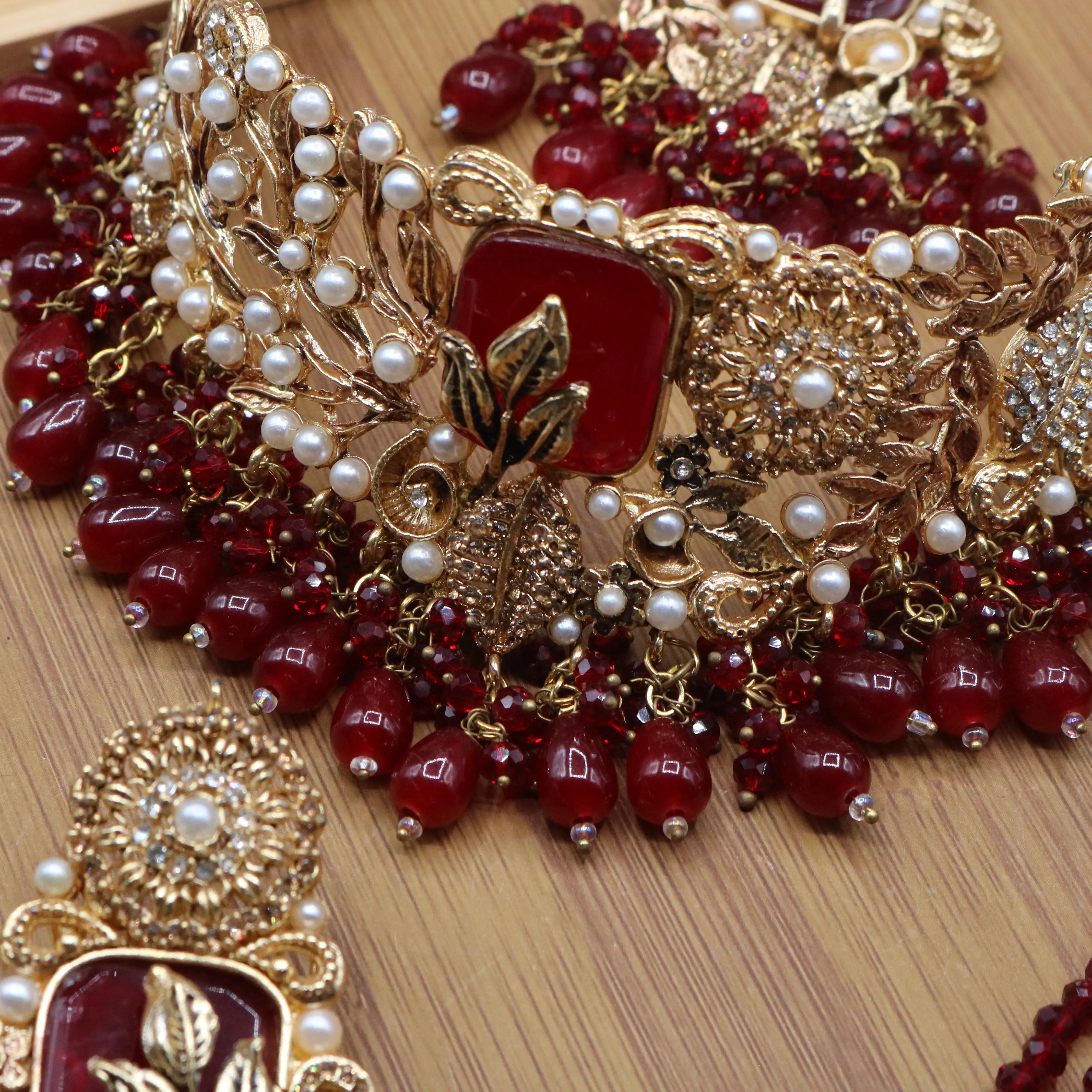 necklace view of Red Pakistani bridal choker necklace with matching mala set. Gold-plated bridal set with American diamonds and red stones