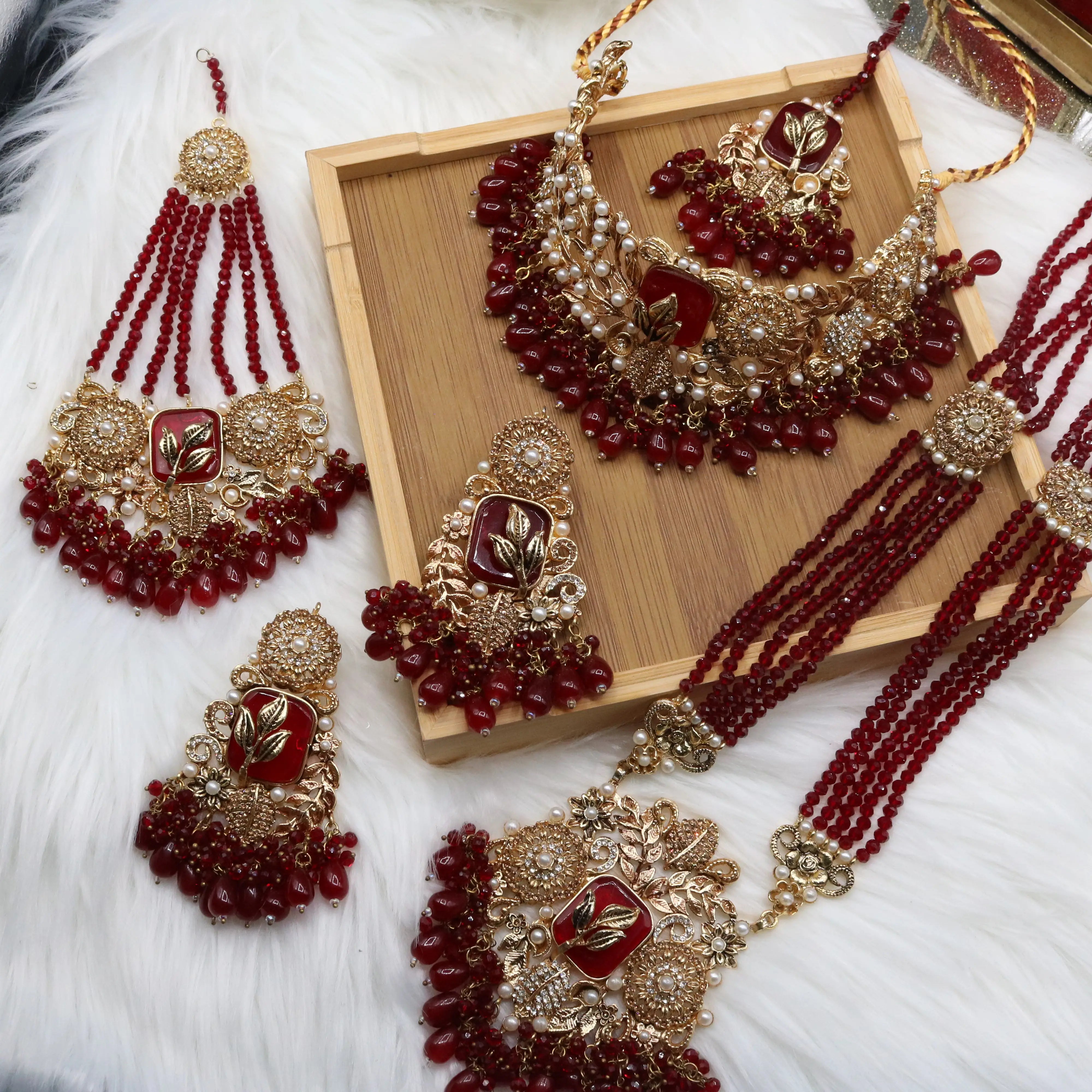Complete Pakistani red bridal jewelry set with earrings, teeka & jhoomer