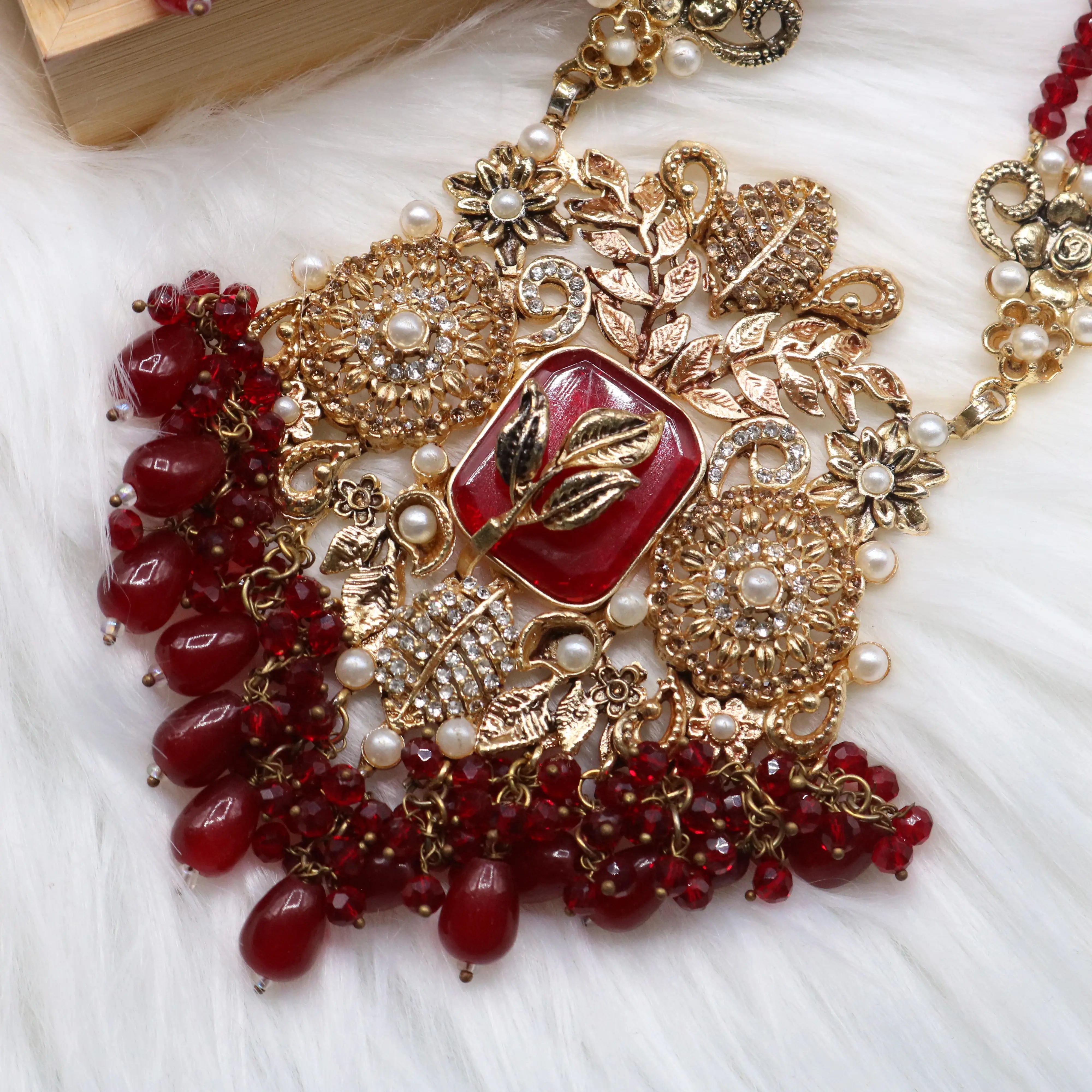 maala pendant view of Red Pakistani bridal choker necklace with matching mala set. Gold-plated bridal set with American diamonds and red stones