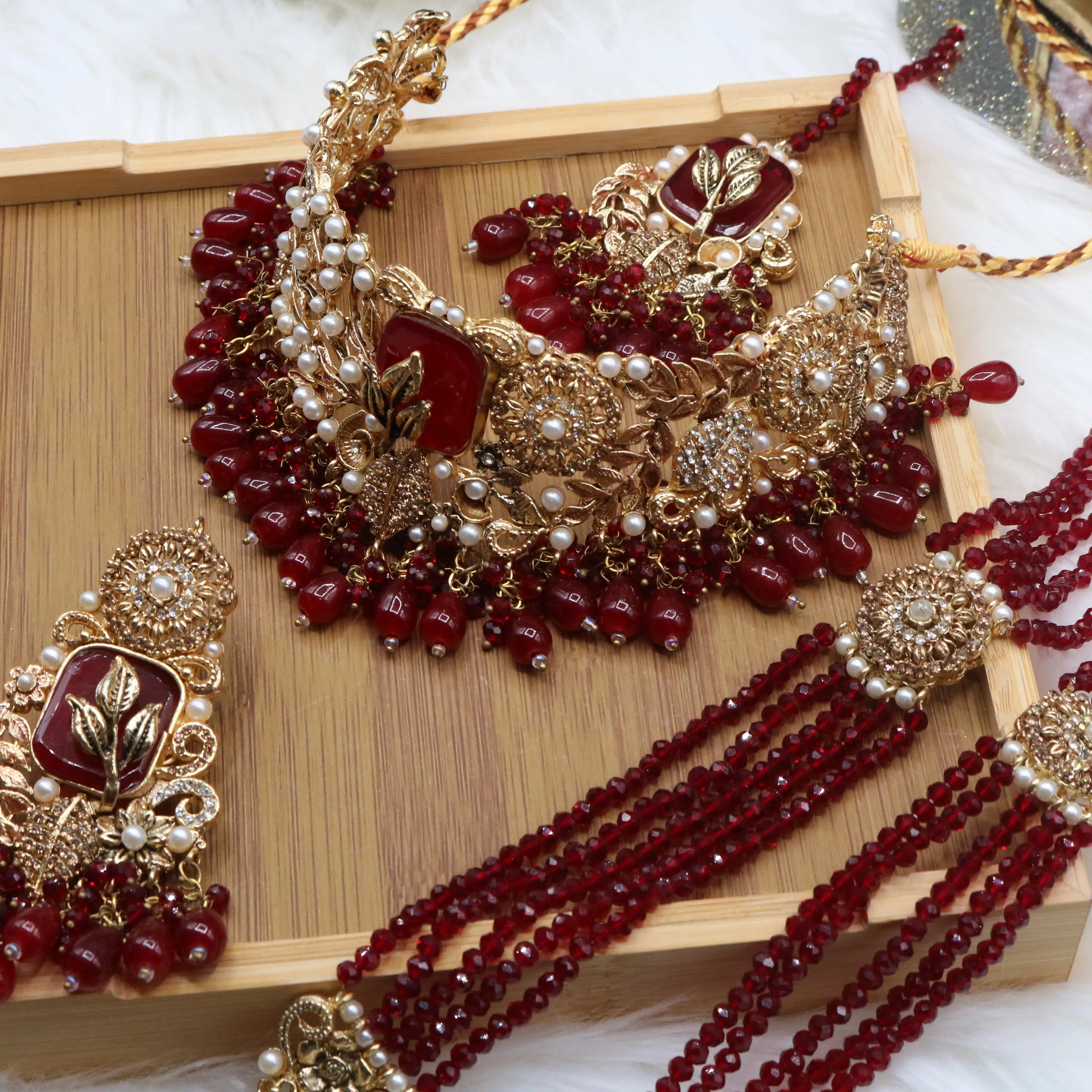 top necklace view of Red Pakistani bridal choker necklace with matching mala set. Gold-plated bridal set with American diamonds and red stones