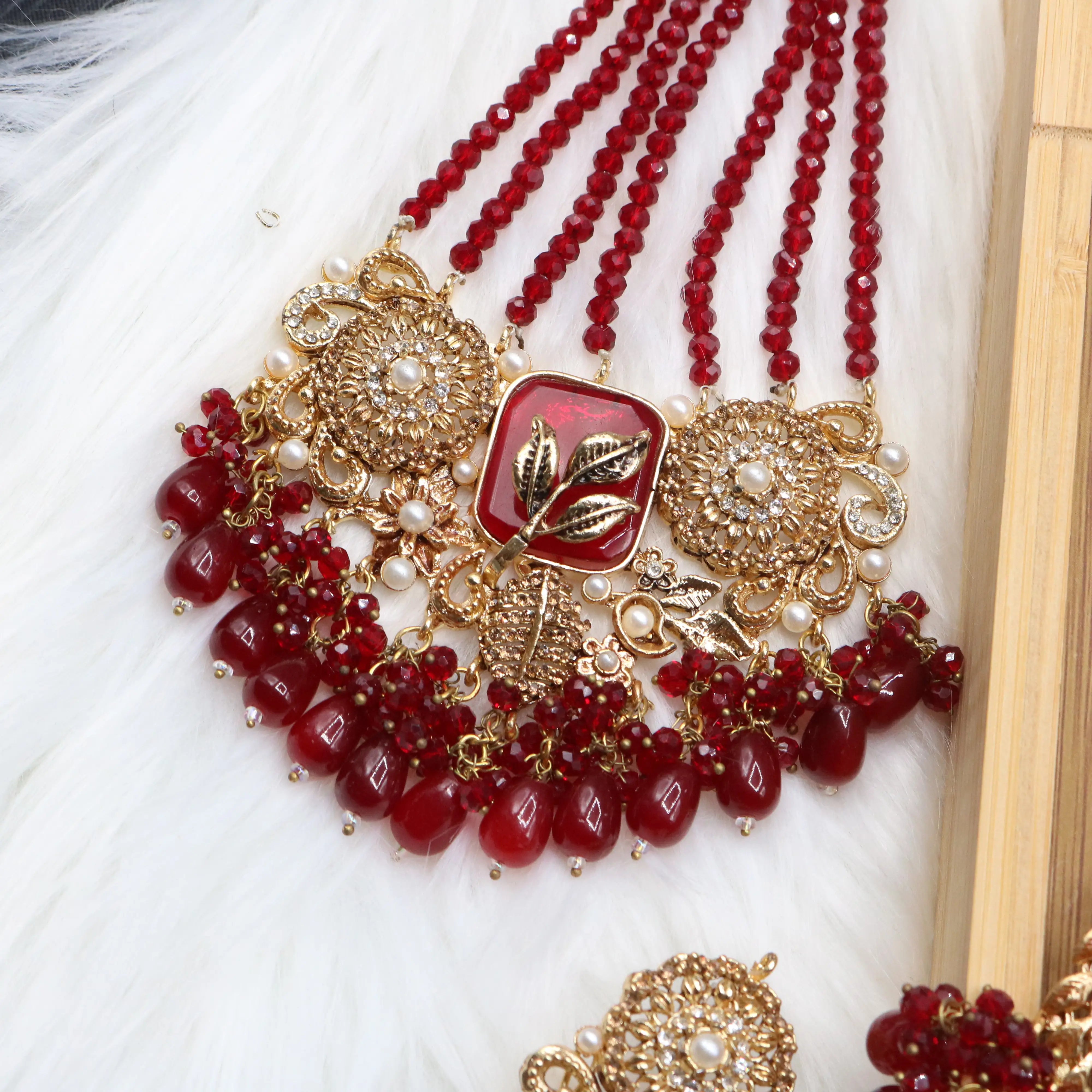 closer jhoomer view of Red Pakistani bridal choker necklace with matching mala set. Gold-plated bridal set with American diamonds and red stones