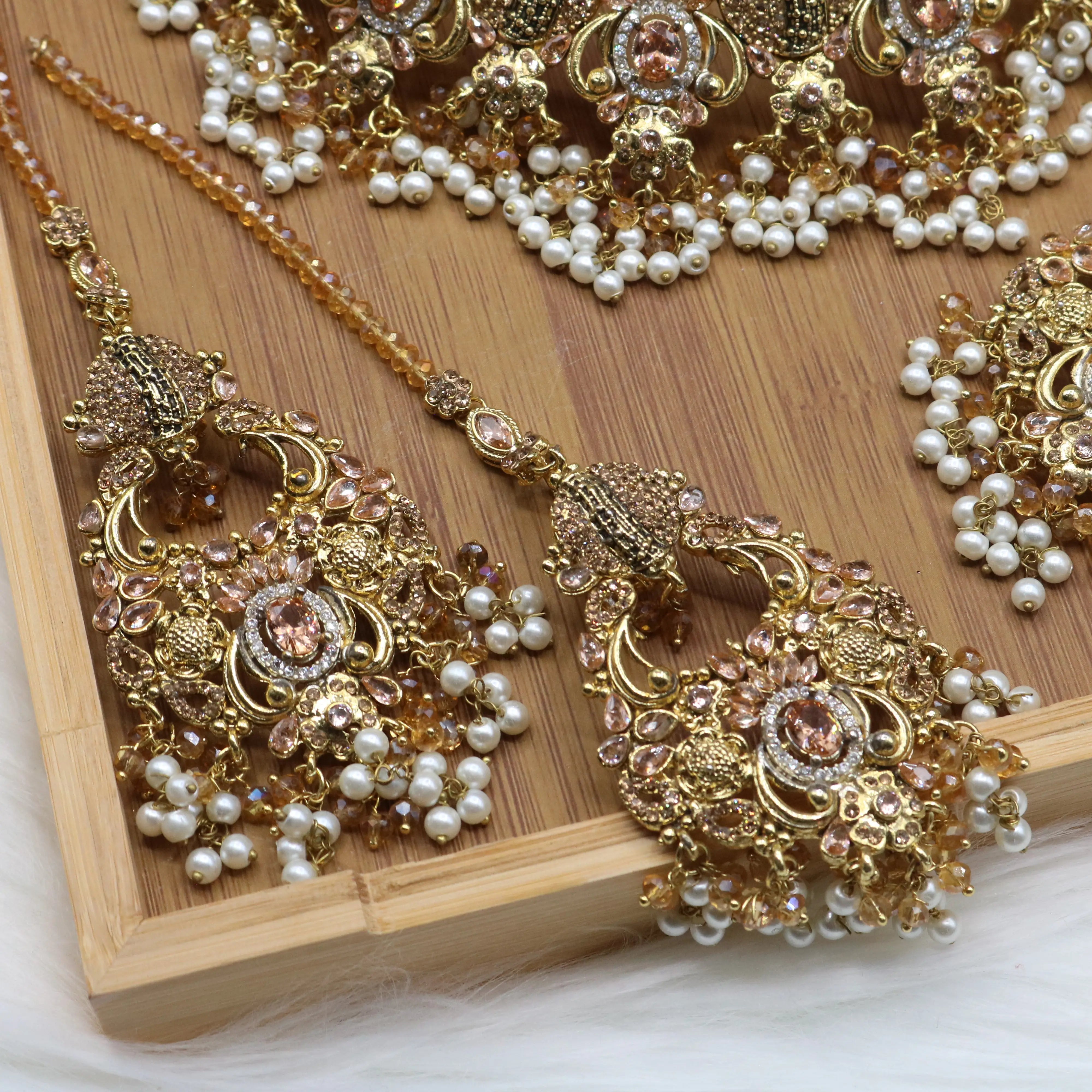 earrings view of Peach Pakistani bridal choker set with pearls and gold-plating. 