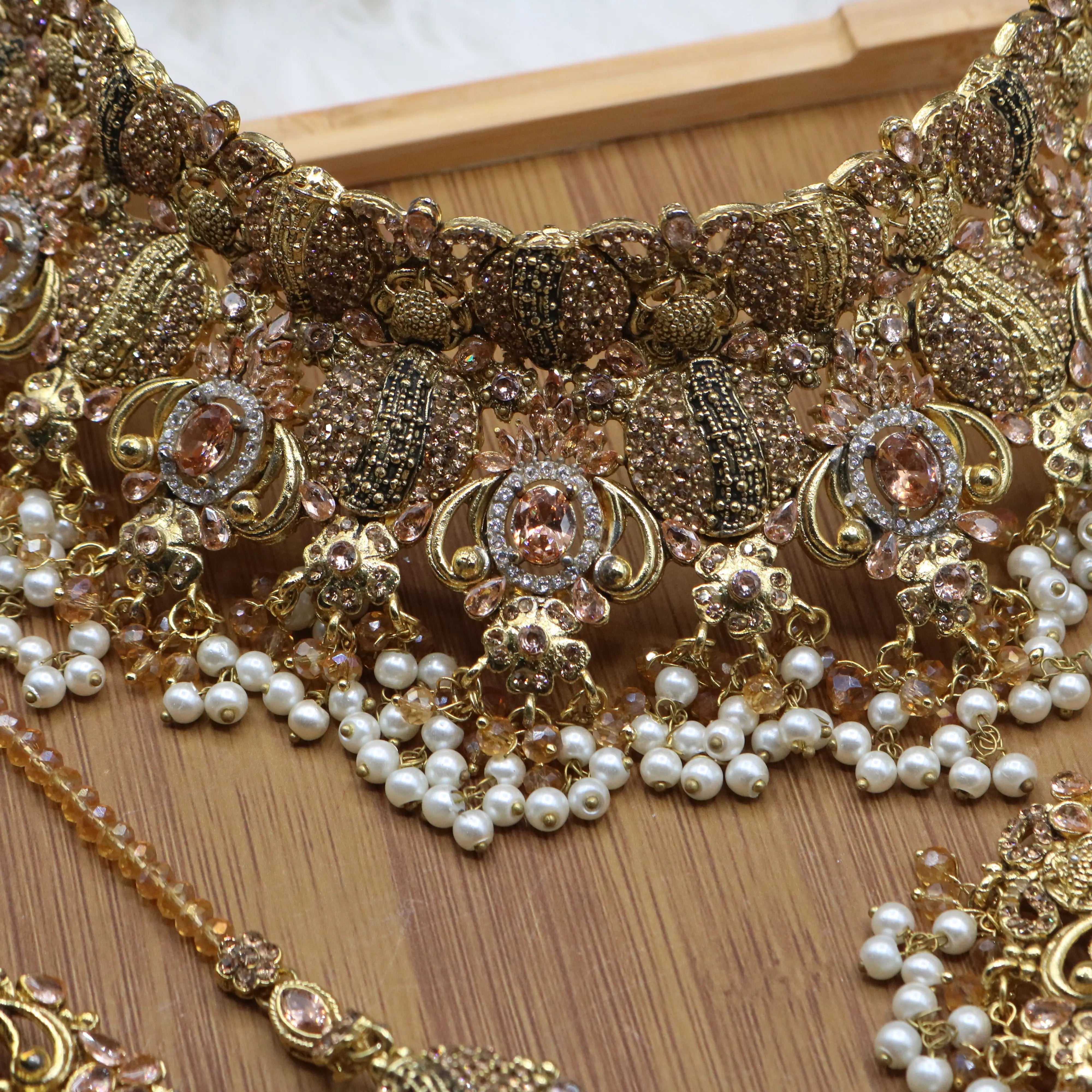 closer necklace view of Peach Pakistani bridal choker set with pearls and gold-plating. 