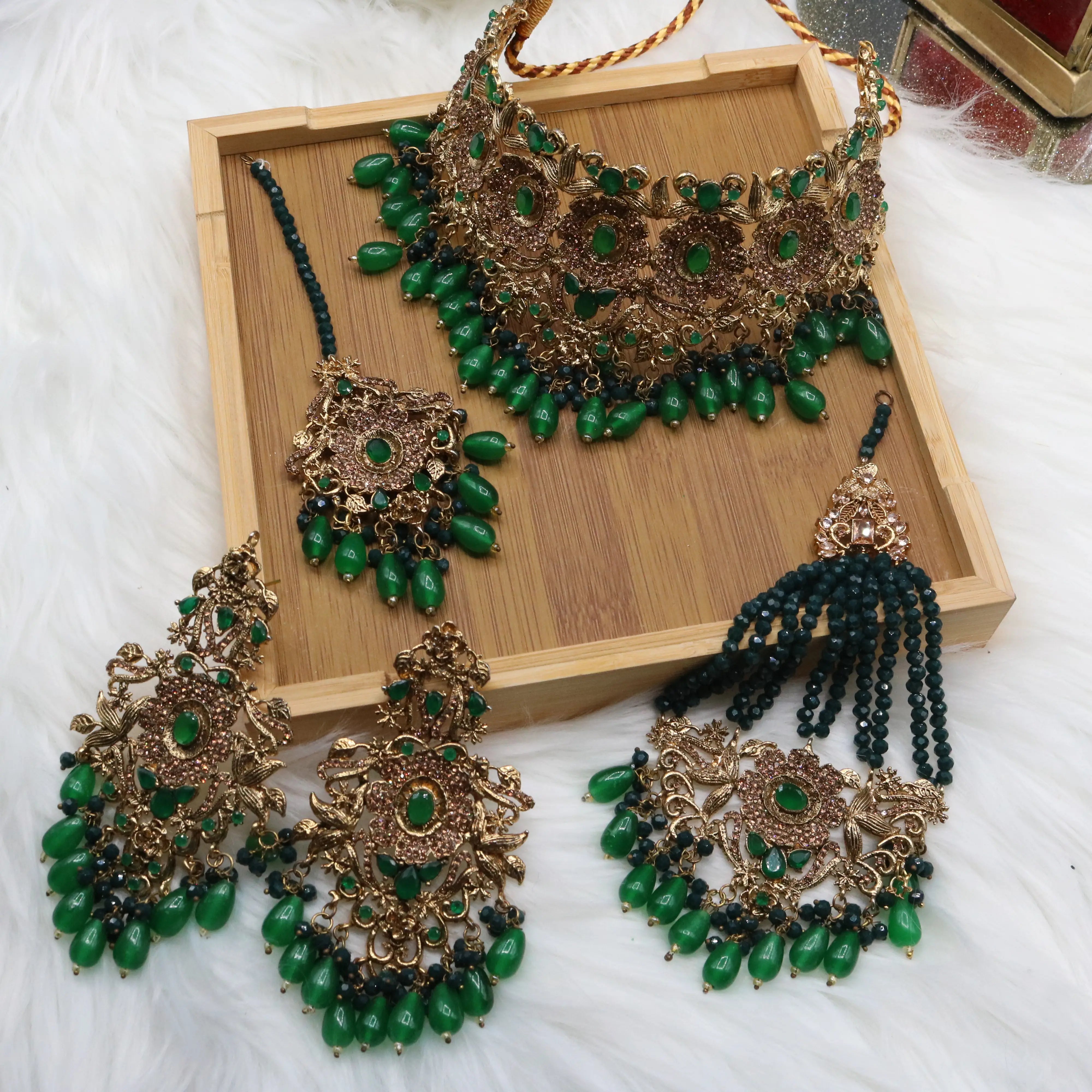 Pakistani bridal jewelry set with green stones and teeka