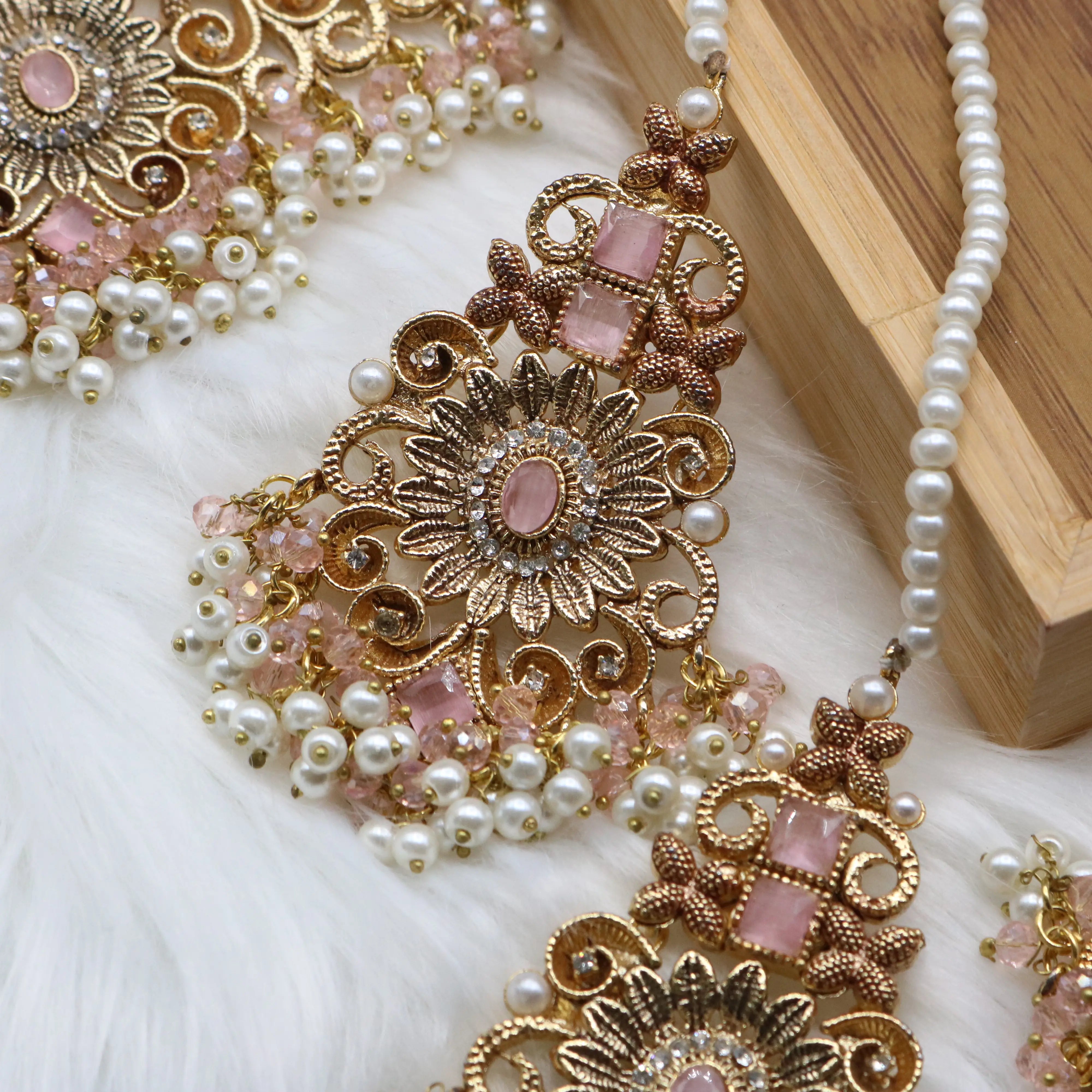earring view of Pink and pearl 6-piece Pakistani bridal jewelry set with choker, long maala, earrings, teeka & jhoomer