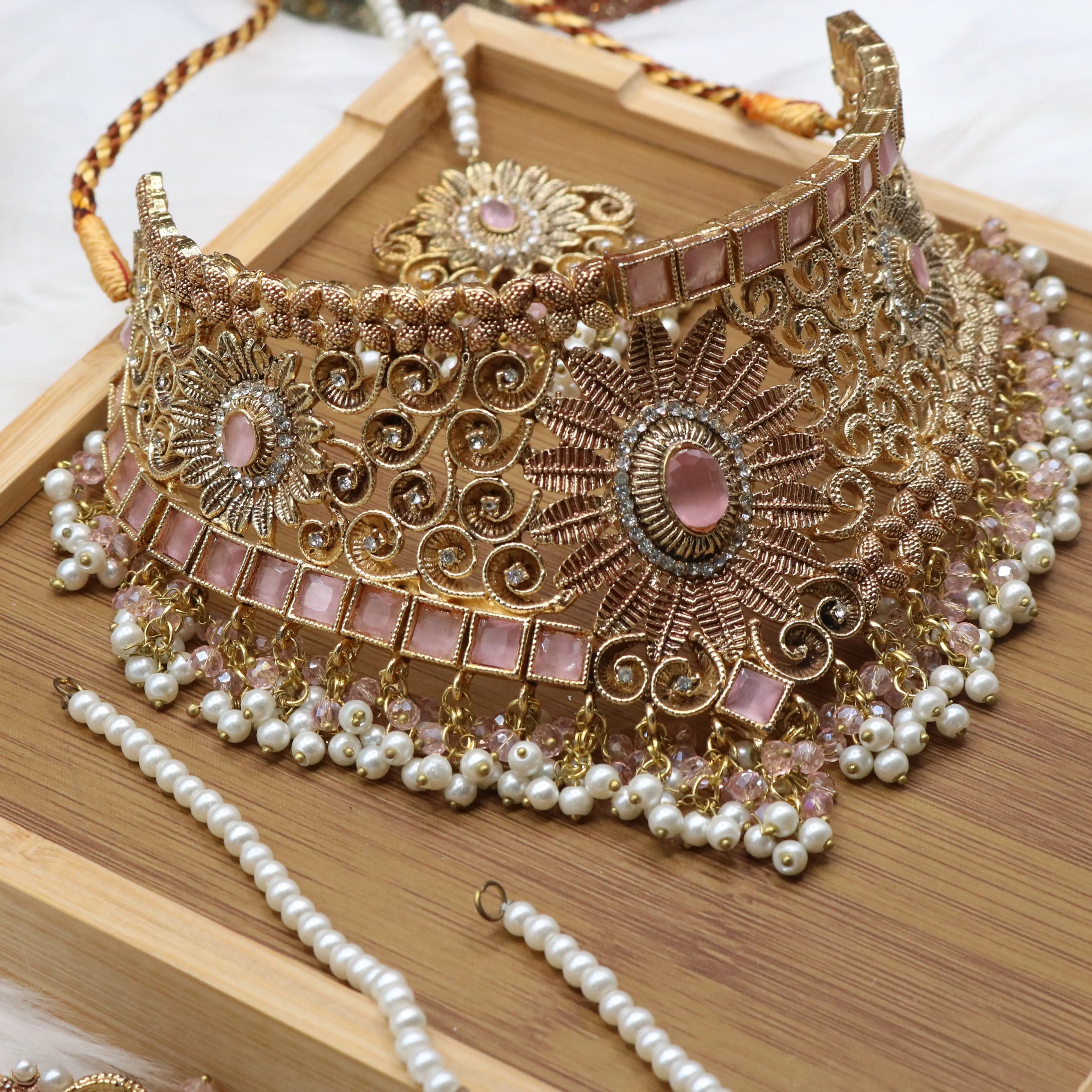another angle of necklace view of Pink and pearl 6-piece Pakistani bridal jewelry set with choker, long maala, earrings, teeka & jhoomer