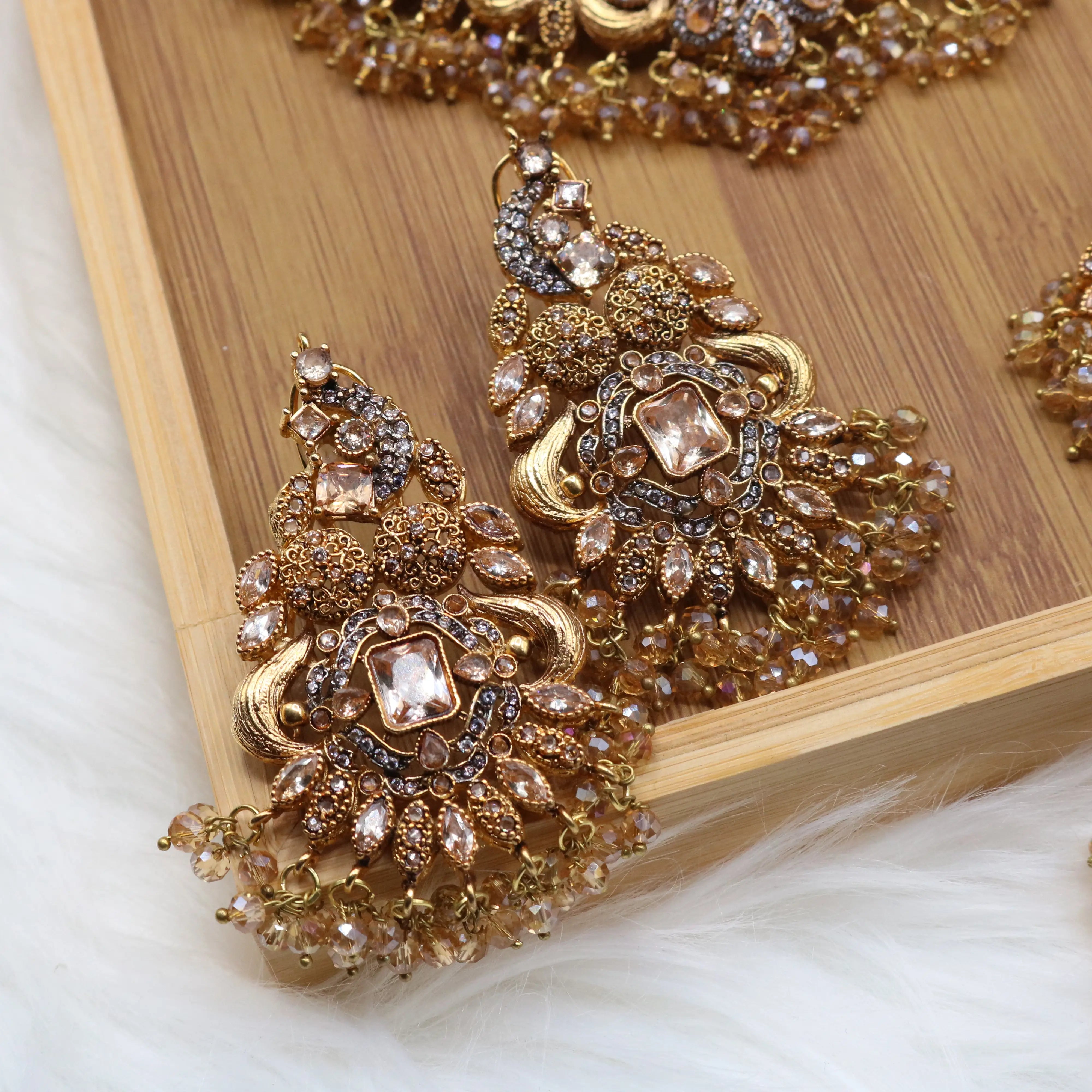 earrings view of Champagne gold Pakistani bridal choker jewelry set with earrings, teeka & jhoomer