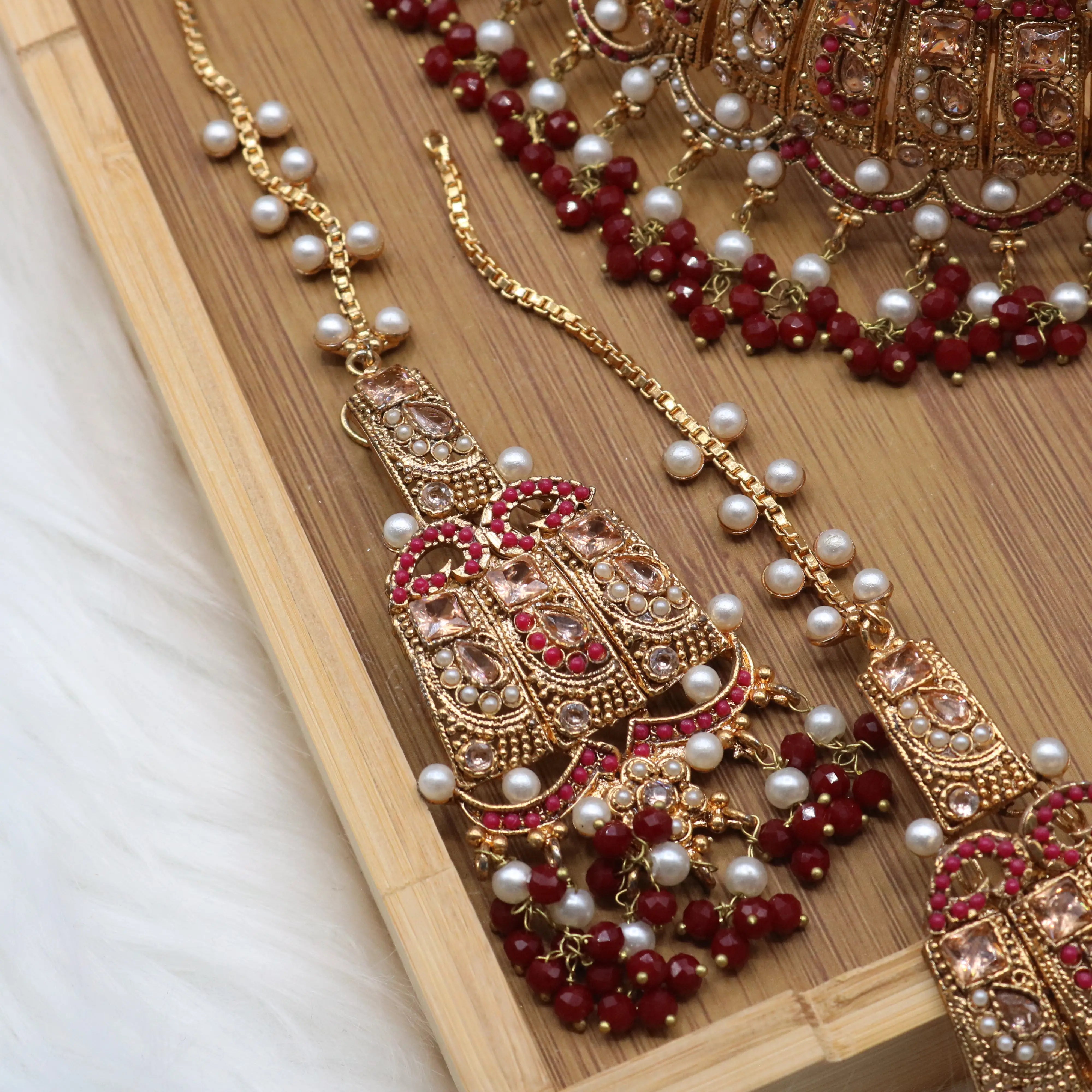 earring view of Pakistani wedding jewelry set with choker, earrings, and jhoomer with red stones