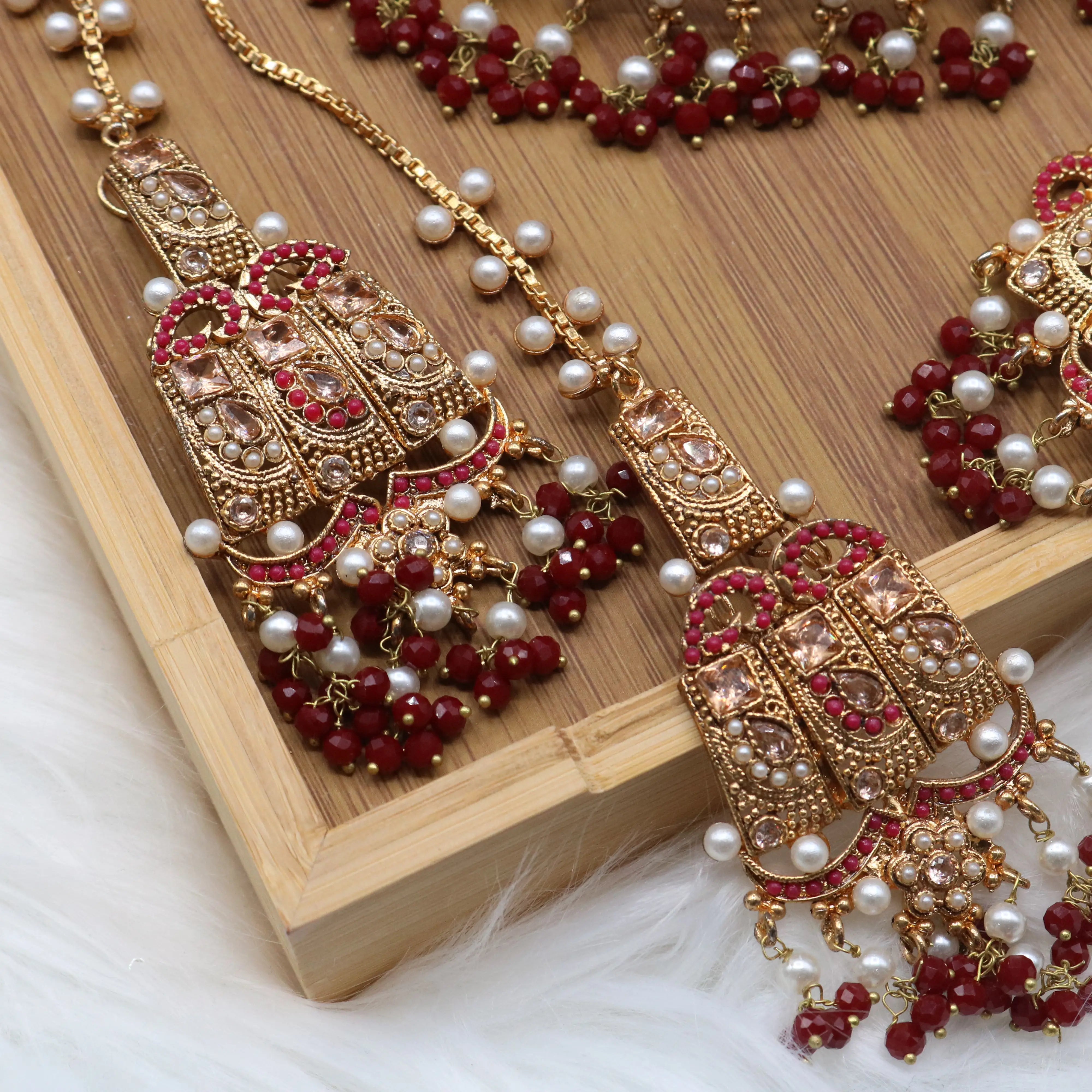 earrings view of Pakistani wedding jewelry set with choker, earrings, and jhoomer with red stones