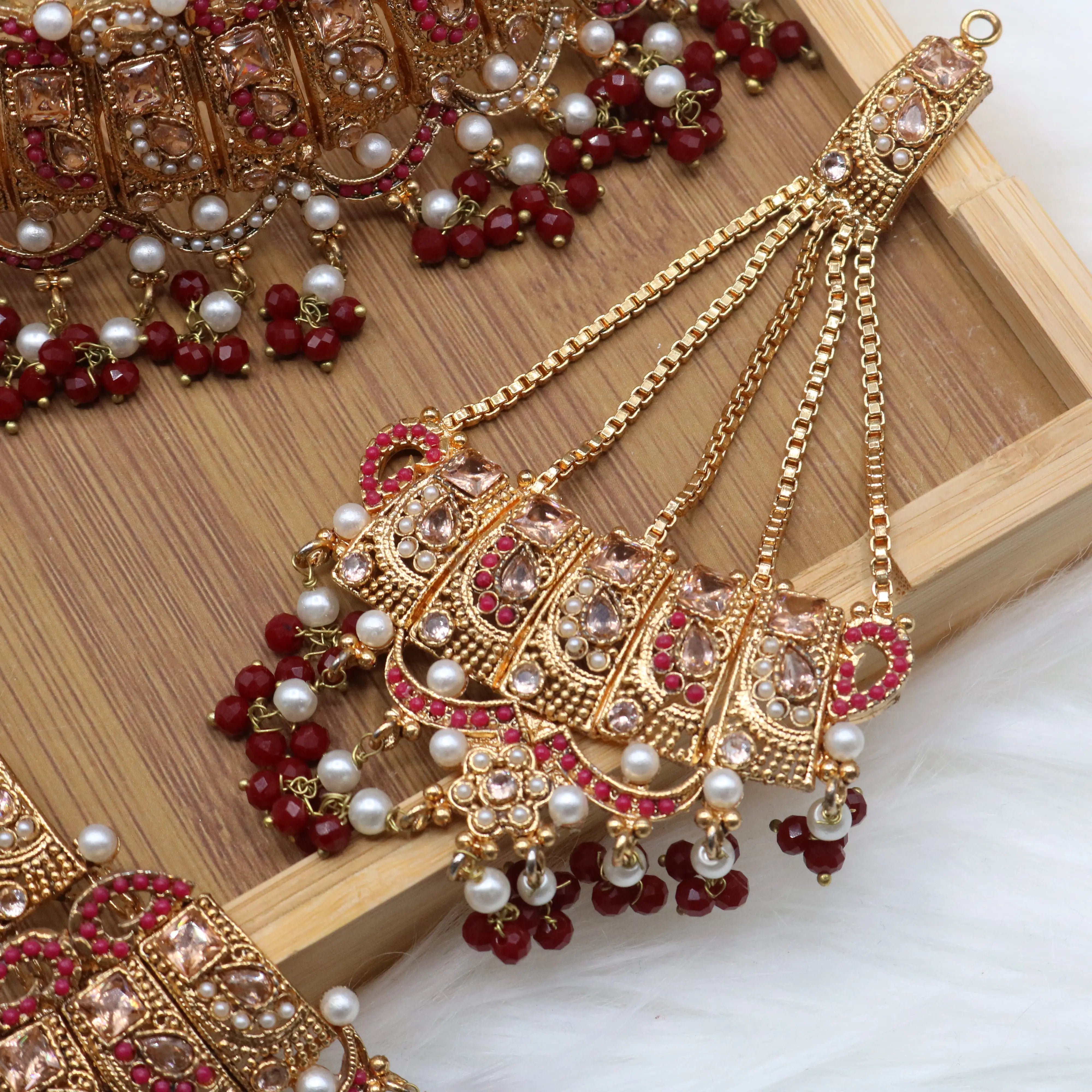 jhoomer view of Pakistani wedding jewelry set with choker, earrings, and jhoomer with red stones