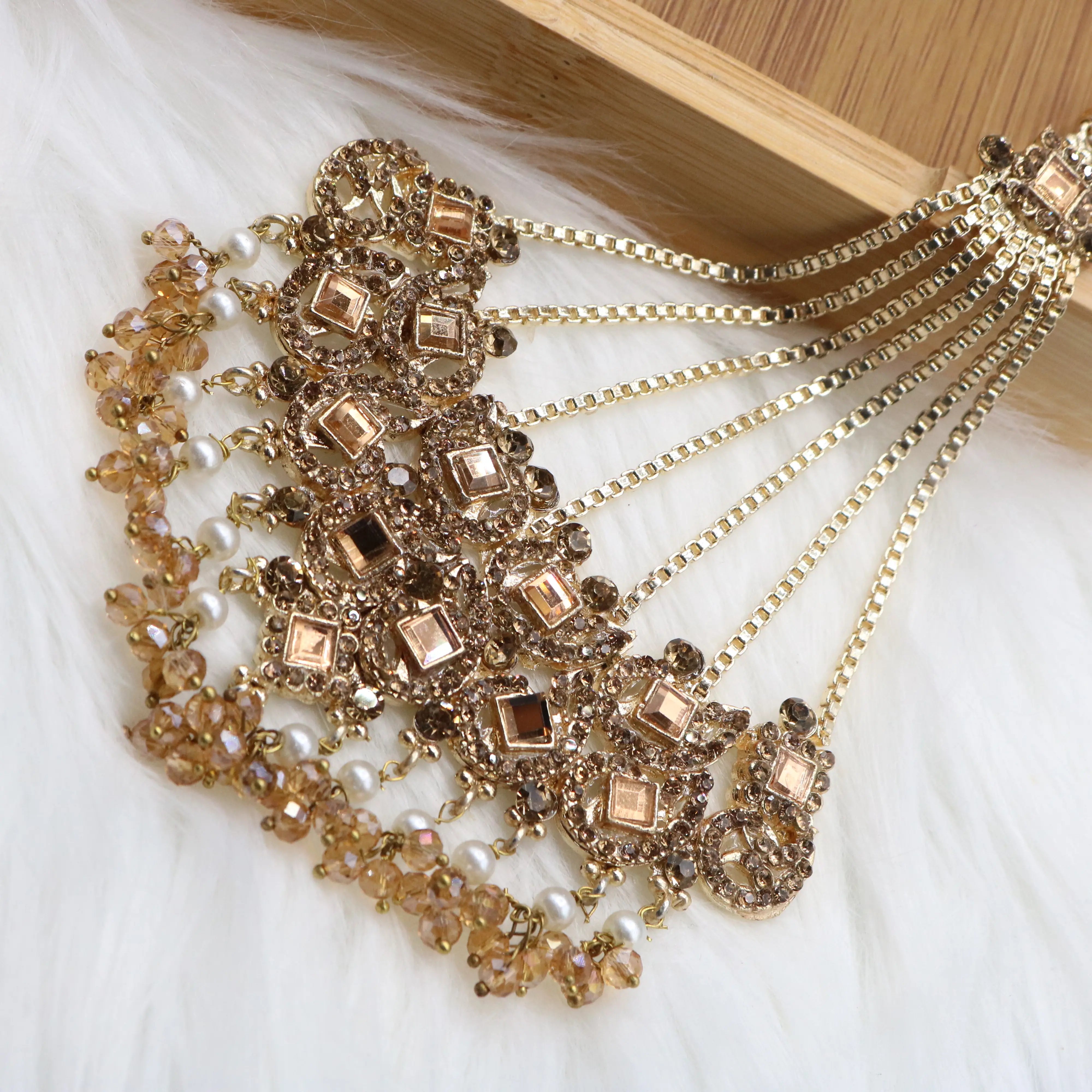 jhoomer view of Champagne gold Pakistani bridal necklace set with earrings, teeka & jhoomer