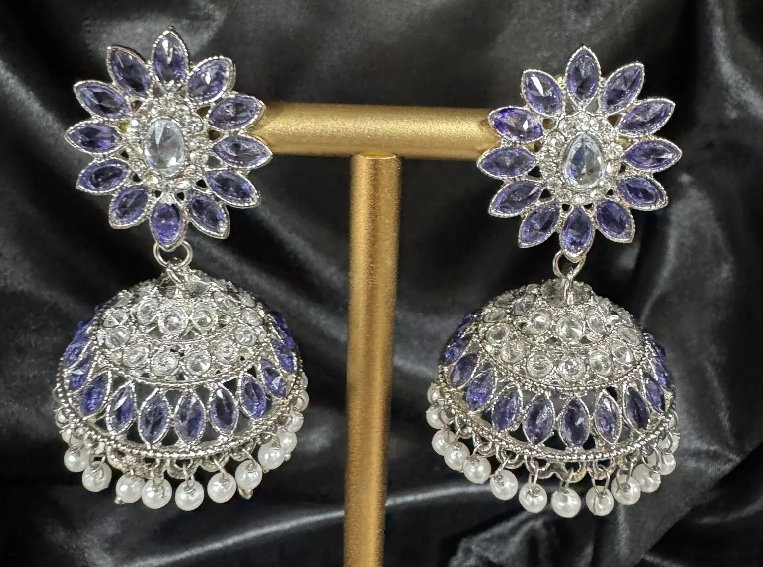 Purple jhumka with silver accent on a black silk background