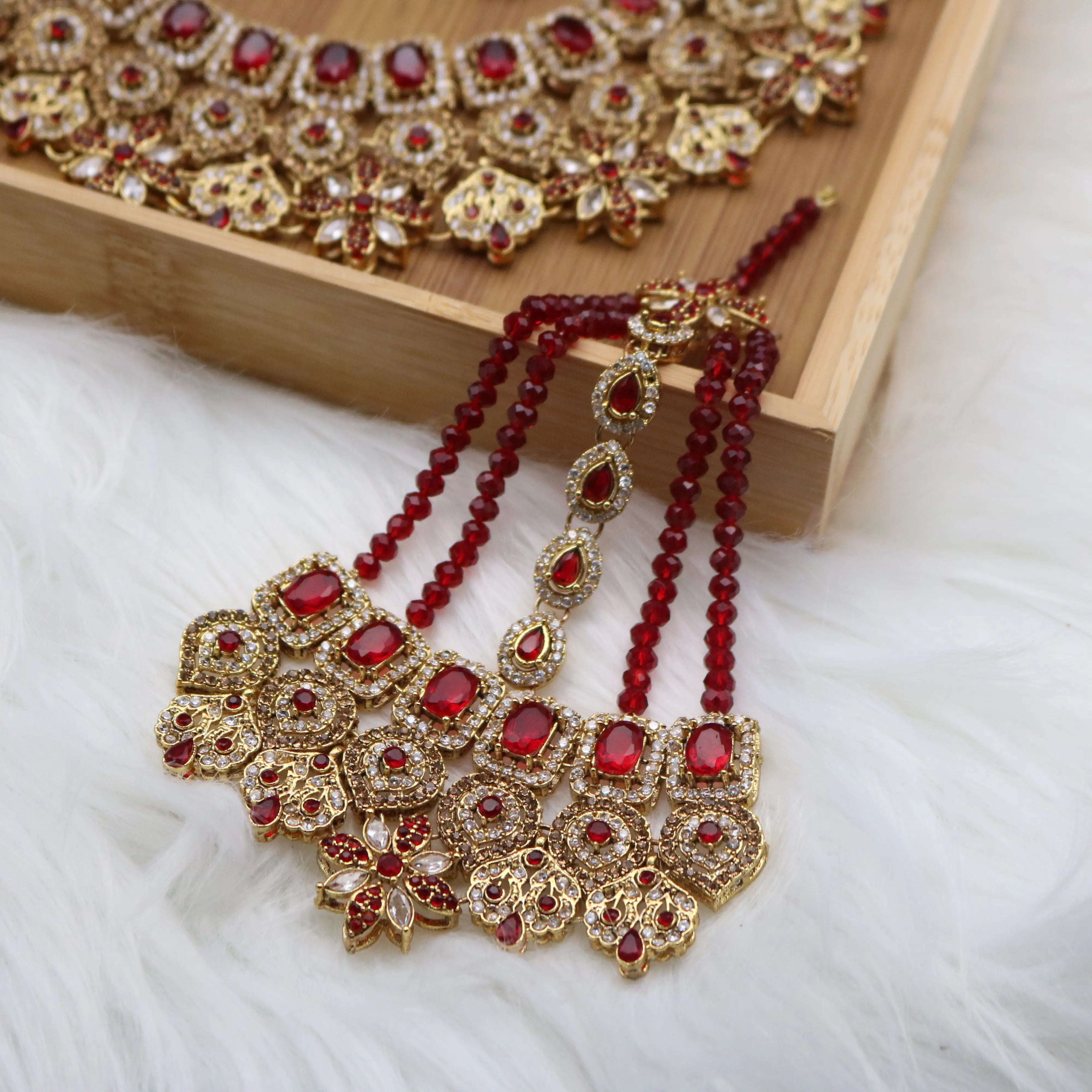 closer view of jhoomer of Red Pakistani bridal necklace set with earrings, teeka & jhoomer
